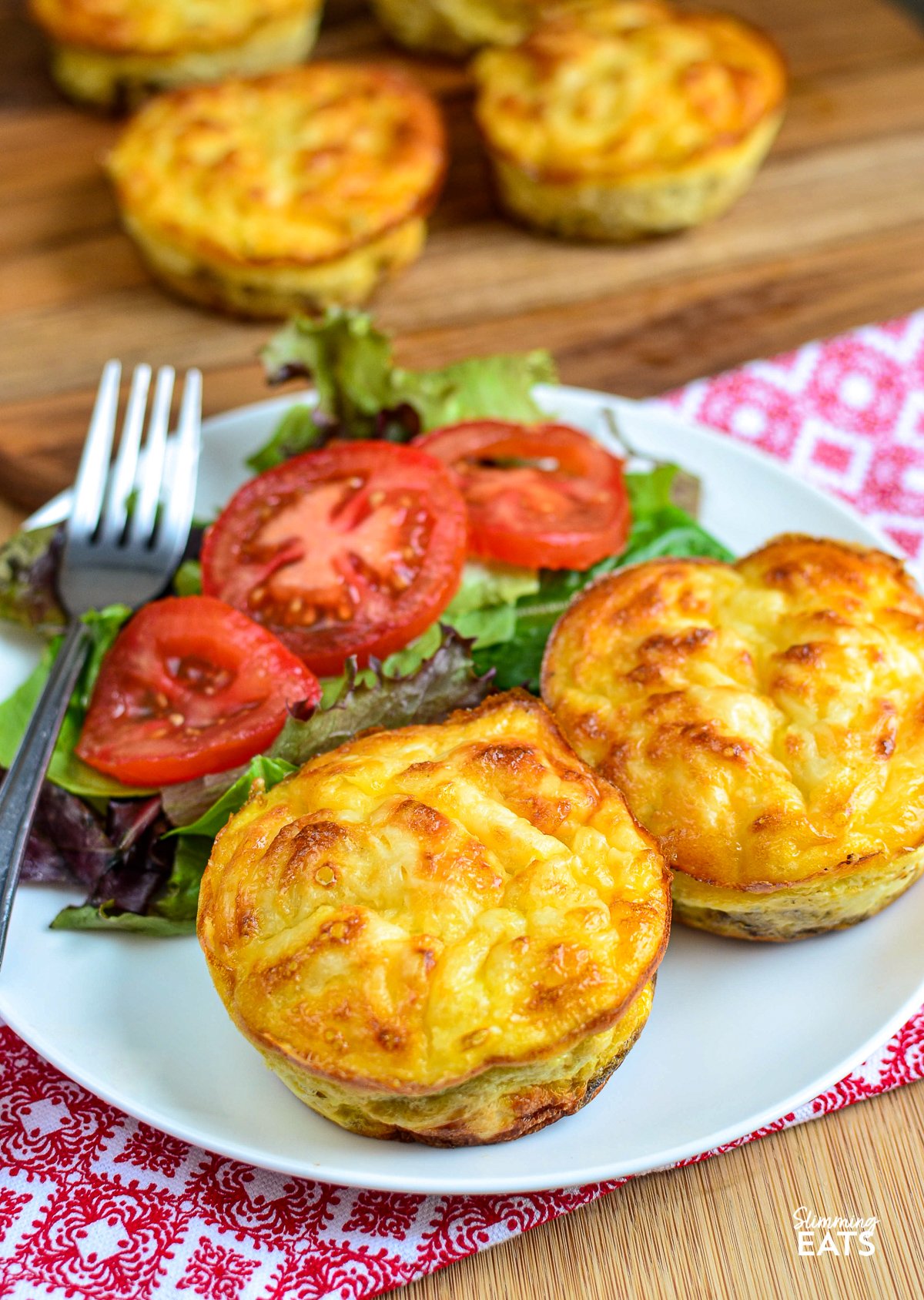 Crustless Tuna and Sweetcorn Mini Quiches- Make up a batch of these delicious mini Tuna and Sweetcorn crustless quiches for an easy grab and go lunch. Gluten Free, Slimming World and Weight Watchers friendly Crustless Tuna and Sweetcorn Mini Quiches on white plate with mixed salad