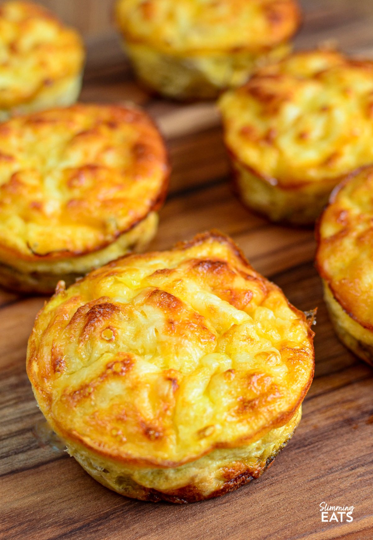 Crustless Tuna and Sweetcorn Mini Quiches- Make up a batch of these delicious mini Tuna and Sweetcorn crustless quiches for an easy grab and go lunch. Gluten Free, Slimming World and Weight Watchers friendly Crustless Tuna and Sweetcorn Mini Quiches on wooden board