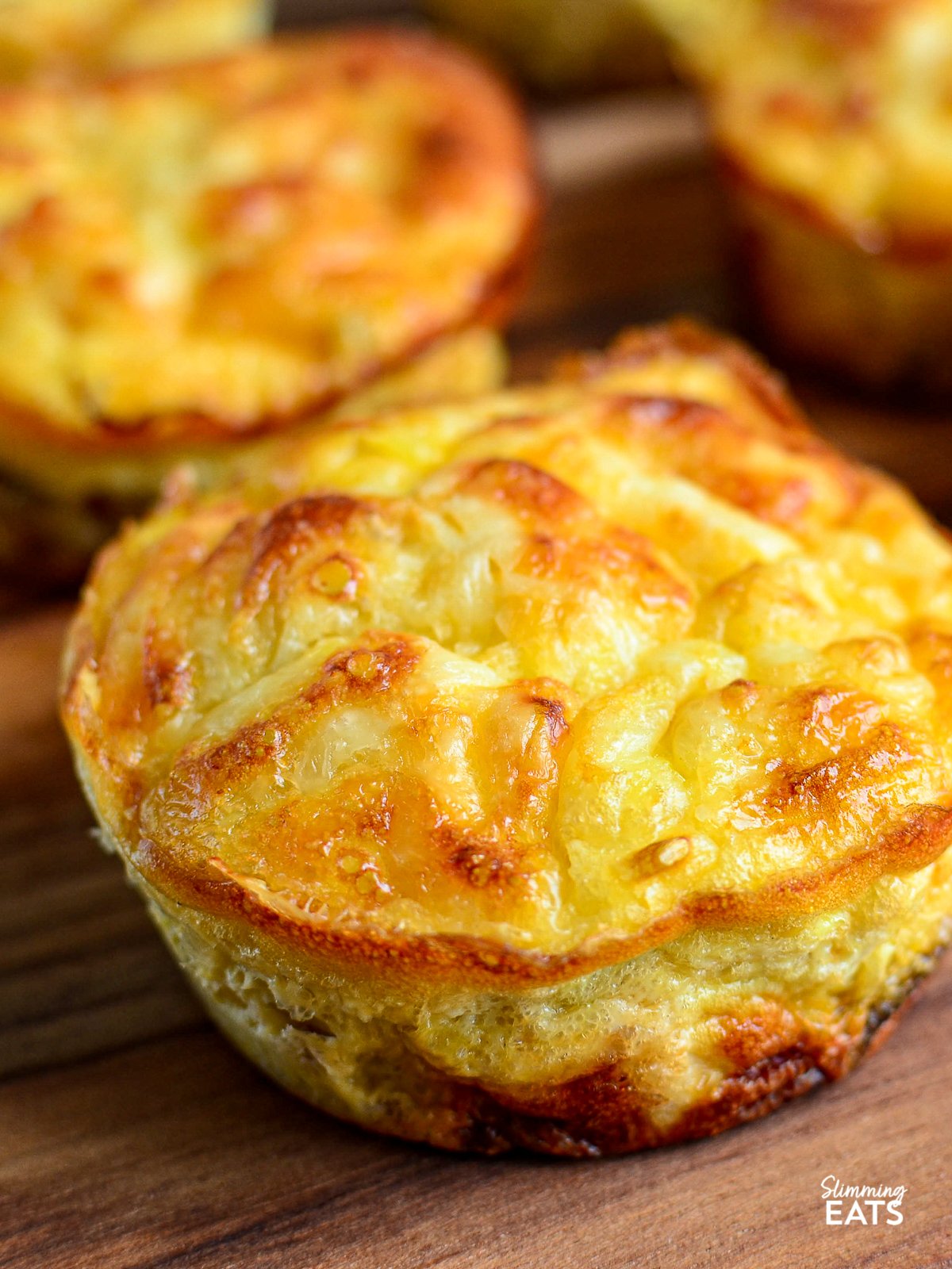 Crustless Tuna and Sweetcorn Mini Quiches- Make up a batch of these delicious mini Tuna and Sweetcorn crustless quiches for an easy grab and go lunch. Gluten Free, Slimming World and Weight Watchers friendly close up of Crustless Tuna and Sweetcorn Mini Quiches on wooden board
