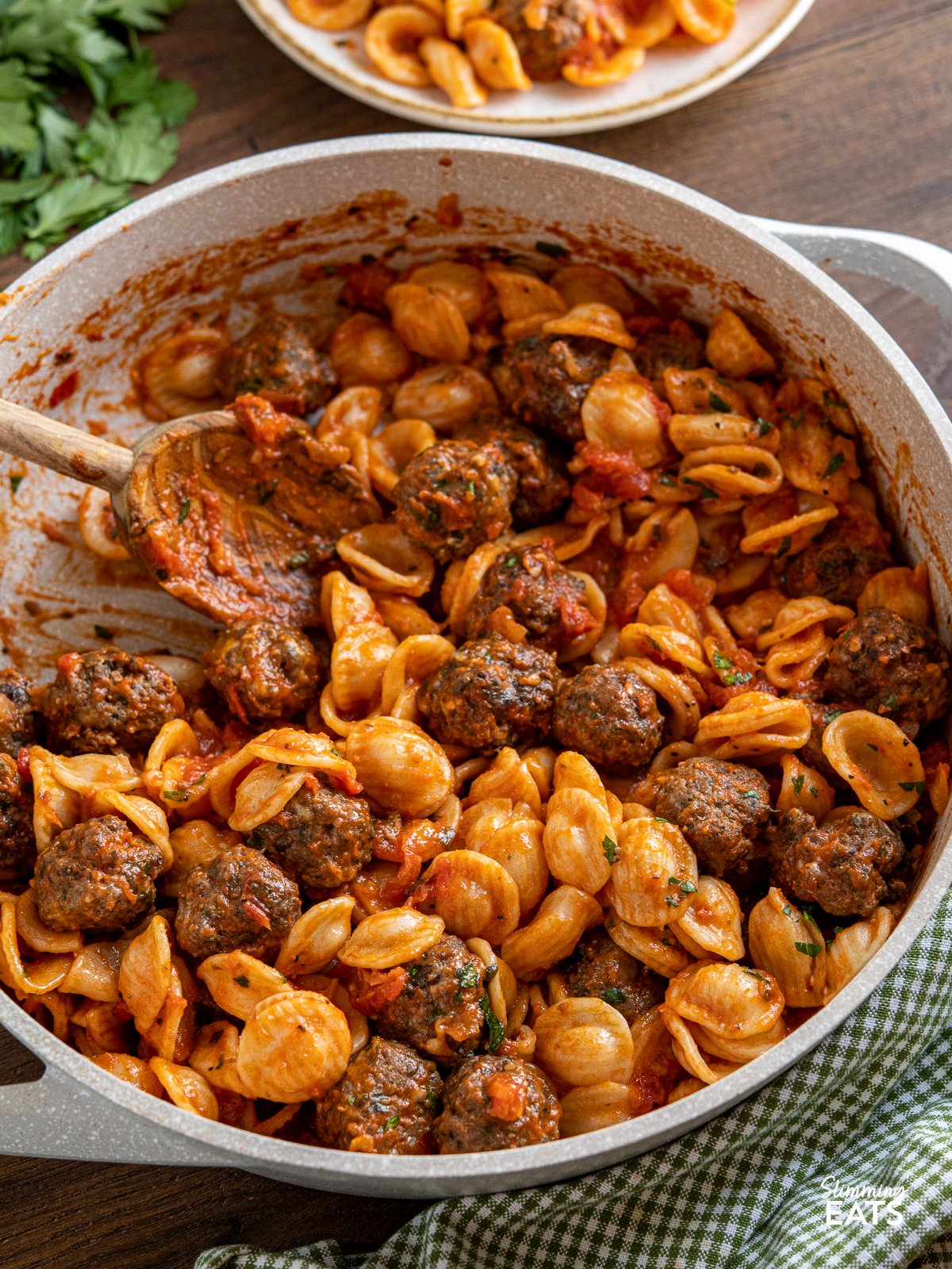 Savoury meatballs with a mixture of ground beef, mushrooms, herbs and parmesan with tender orecchiette pasta in a delicious pasta sauce made from fresh tomatoes and garlic. A hearty comforting meal that is perfect for any occasion. Mini Beef Mushroom Meatballs with Orecchiette in ceramic non stick frying pan with two handles