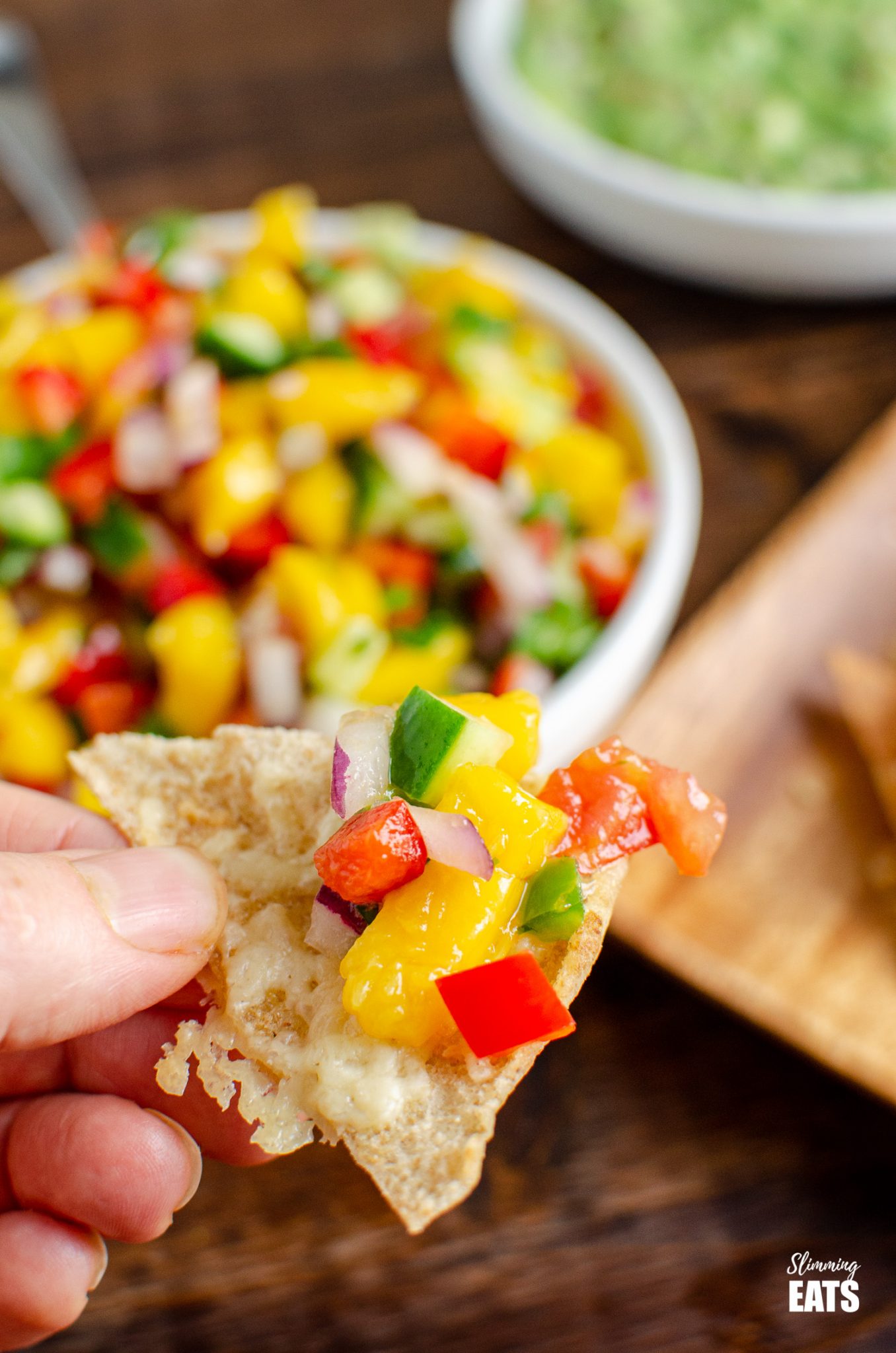 close up of mango salsa on a oven baked cheddar pitta chip