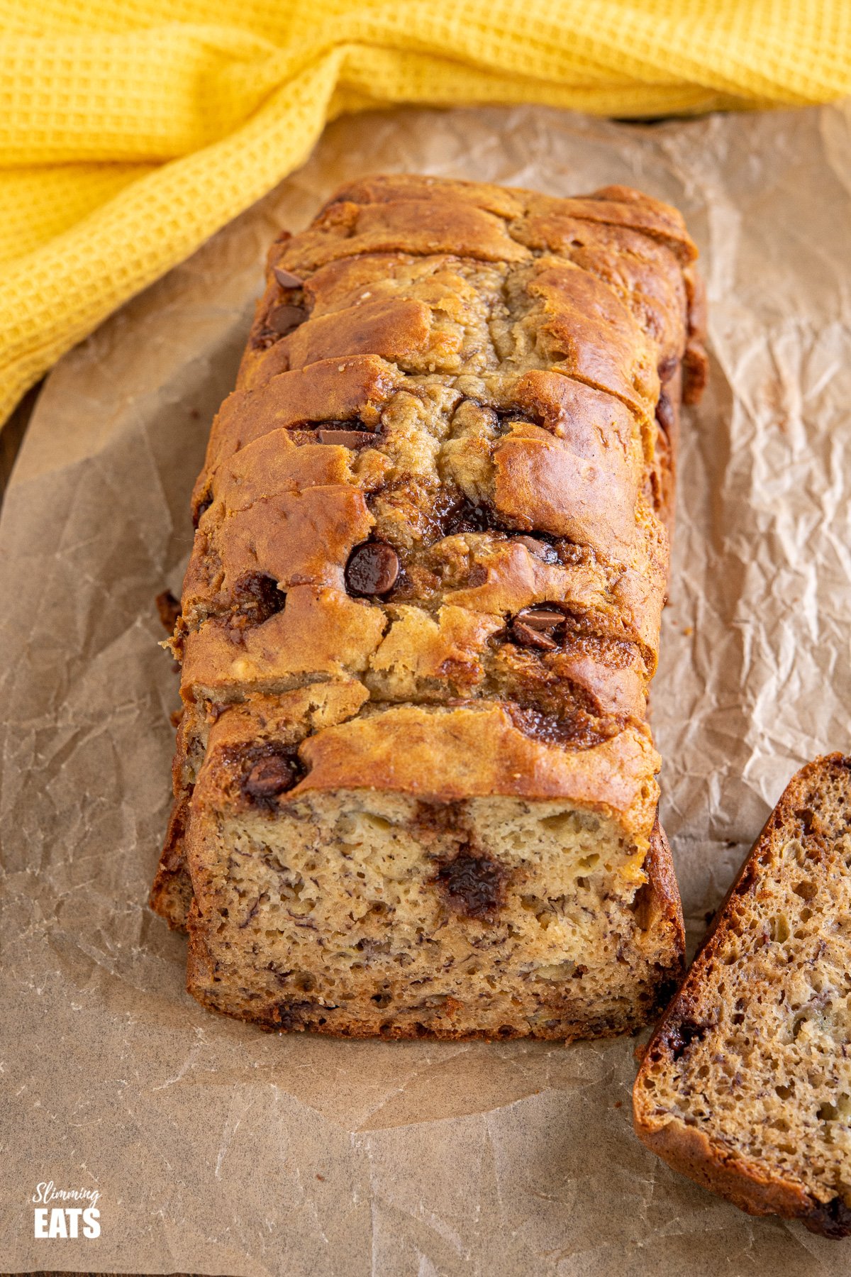 Delicious Healthy Banana and Chocolate Chip Loaf - all natural ingredients and no compromising on taste. #banana #cake #chocolate #slimming #weightwatchers close up of Healthy Banana and Chocolate Chip Loaf on parchment paper