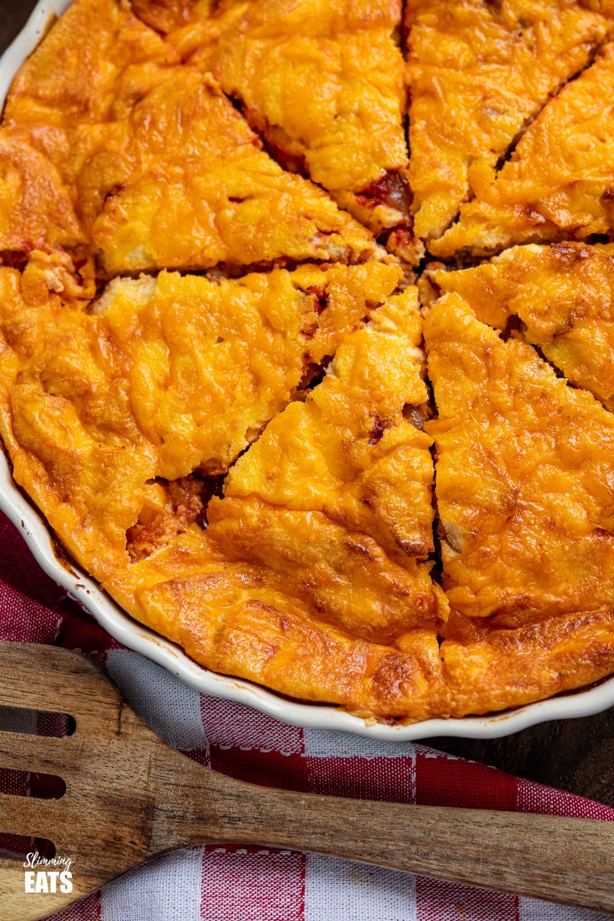 Delicious Cheeseburger Quiche - yes this really is all the great things about a Cheeseburger made into a delicious Slimming Eats friendly crustless quiche. If you make anything, make this!! #slimmingeats #weighwatchers close up of sliced cheeseburger quiche in a dish