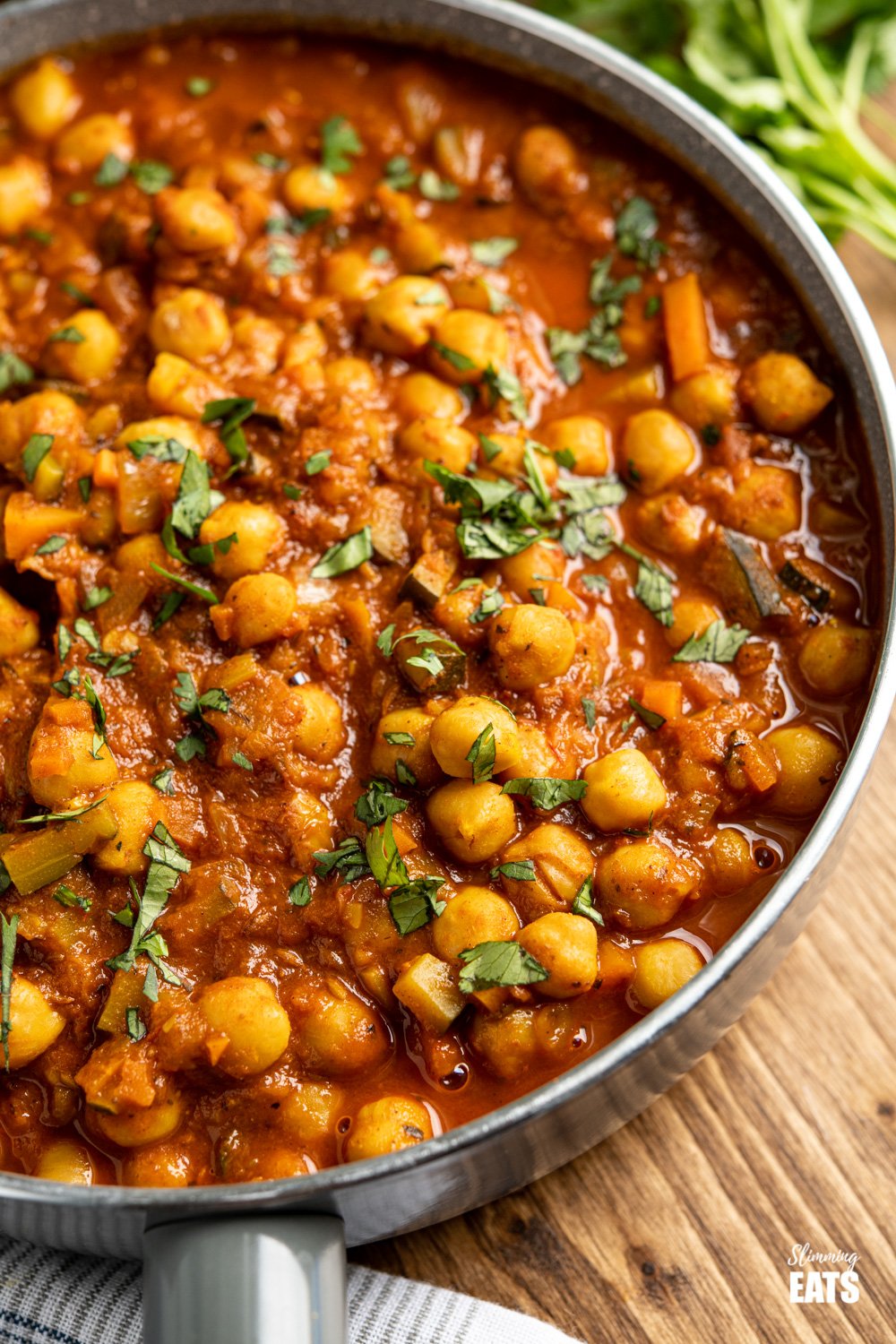 Chana Masala close up in grey frying pan on wooden board