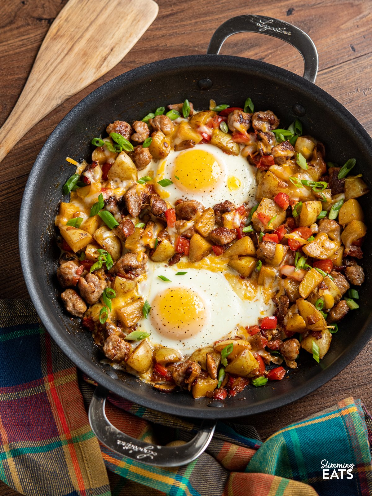 Super easy one pan breakfast skillet - with sausages, potato, peppers onion and perfectly cooked eggs.