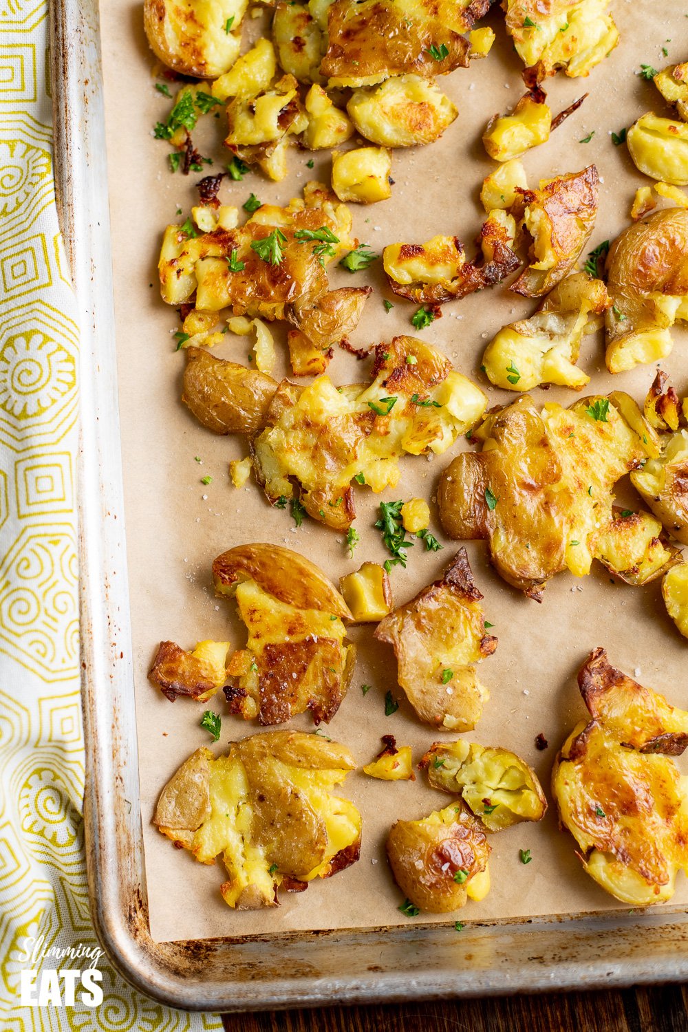 crushed roast potatoes on baking tray