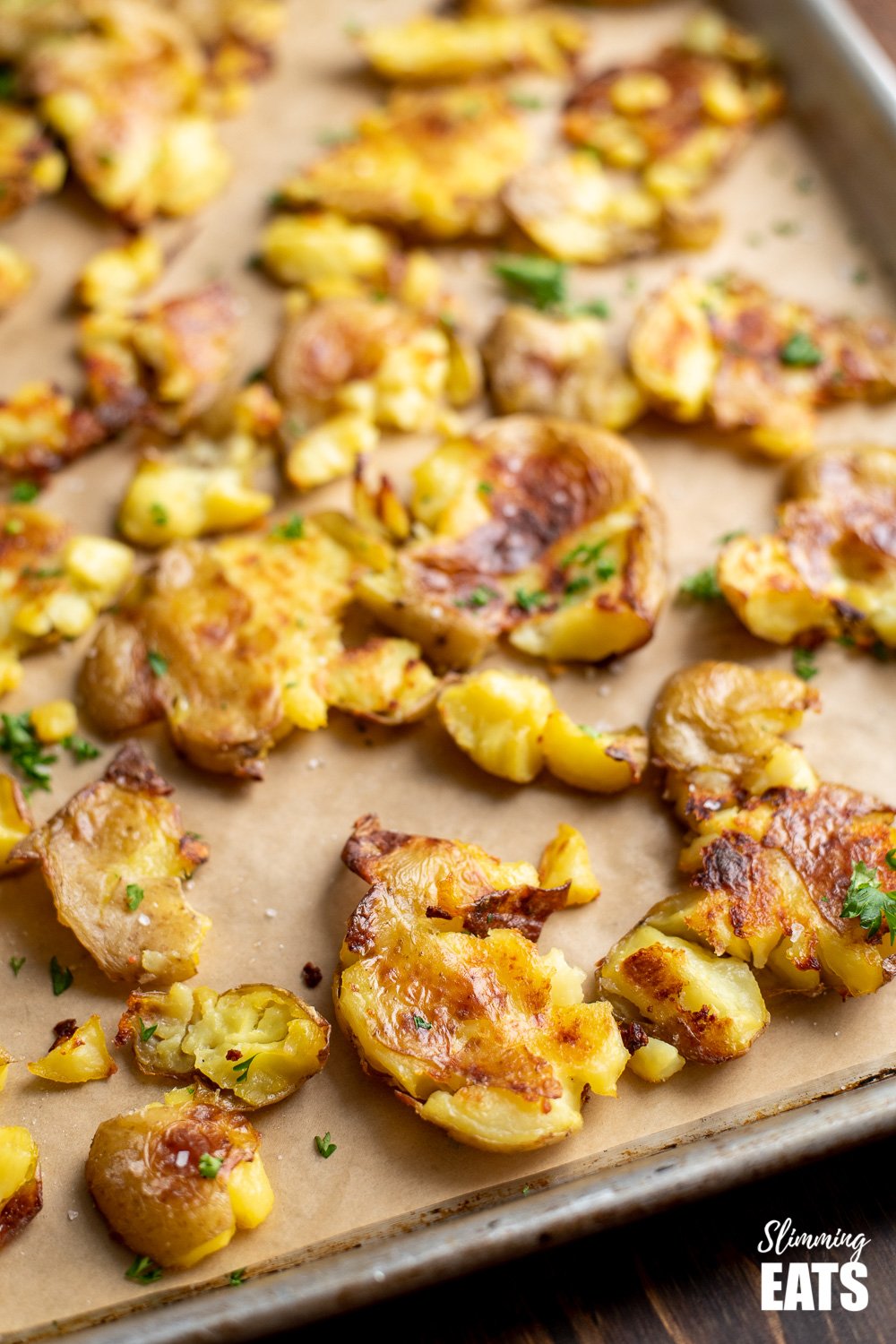 Crispy Golden Crushed Roast Potatoes - the ultimate side to any meal and totally addictive!! Gluten Free, Dairy Free, Vegan, Whole30, Slimming and Weight Watchers friendly close up of crushed roast potatoes