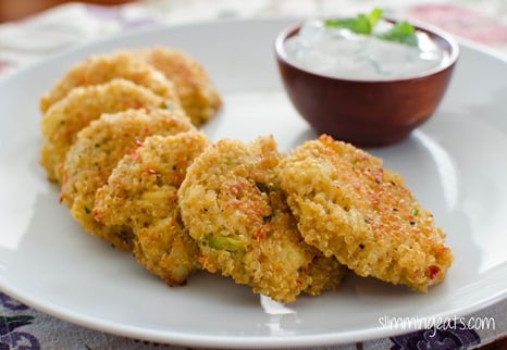 Crab and Quinoa Cakes on white plate with little wooden bowl with yoghurt dip