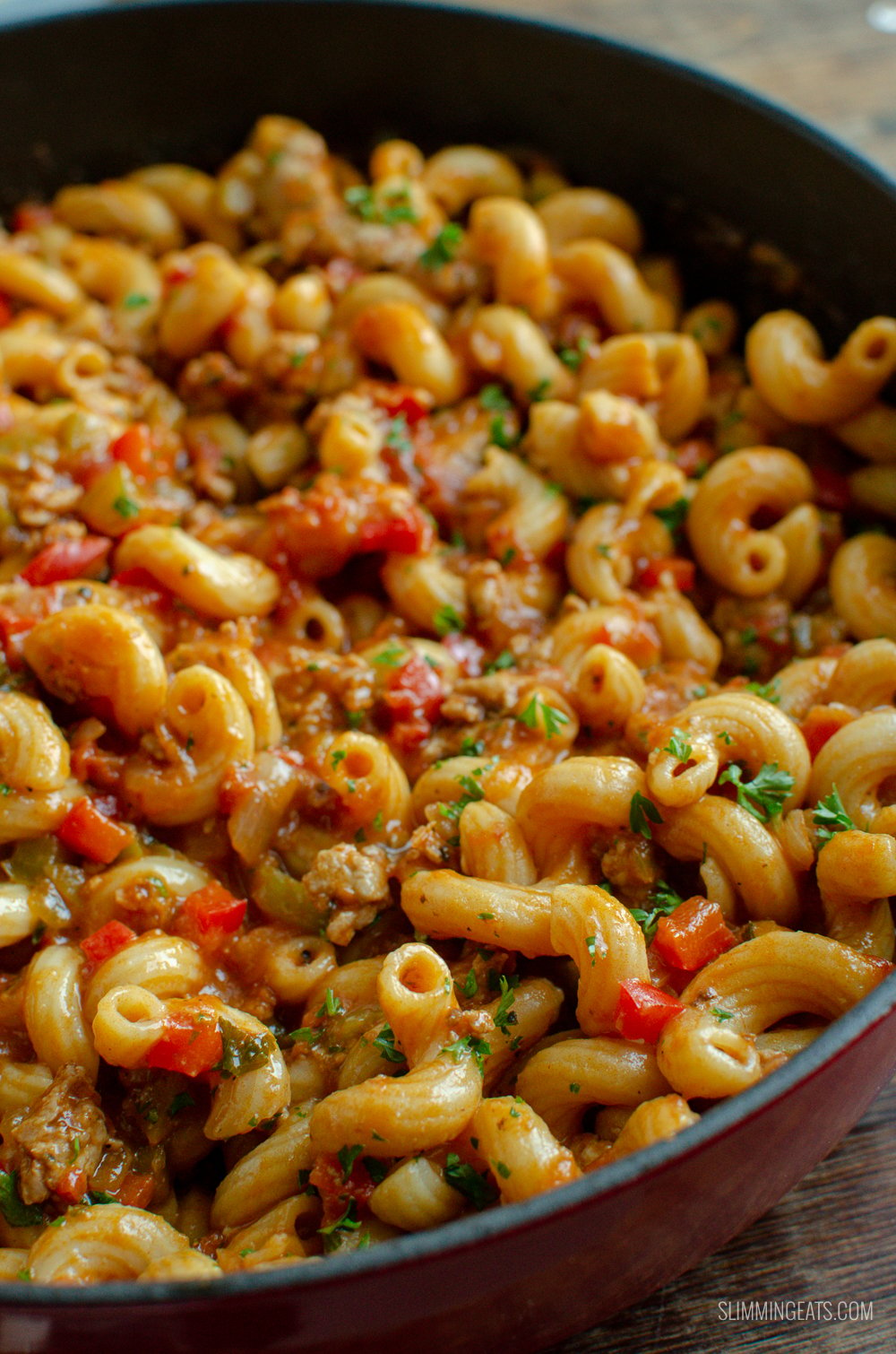 close up of sausage and tomato pasta in a cast iron skillet