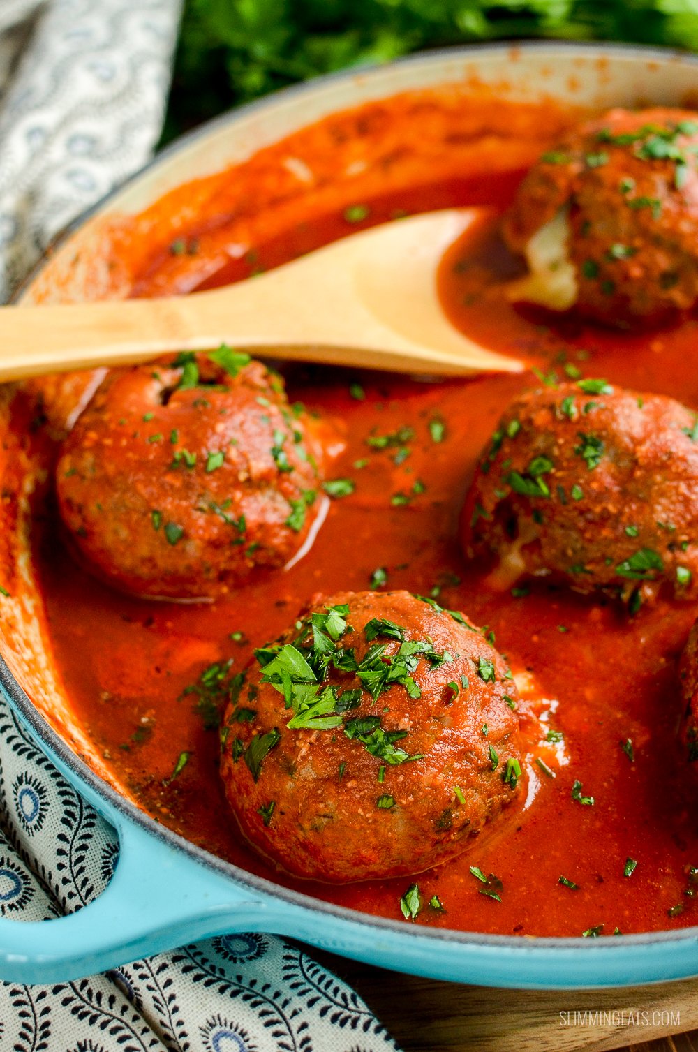 mega stuffed meatballs in cast iron pan with tomato sauce