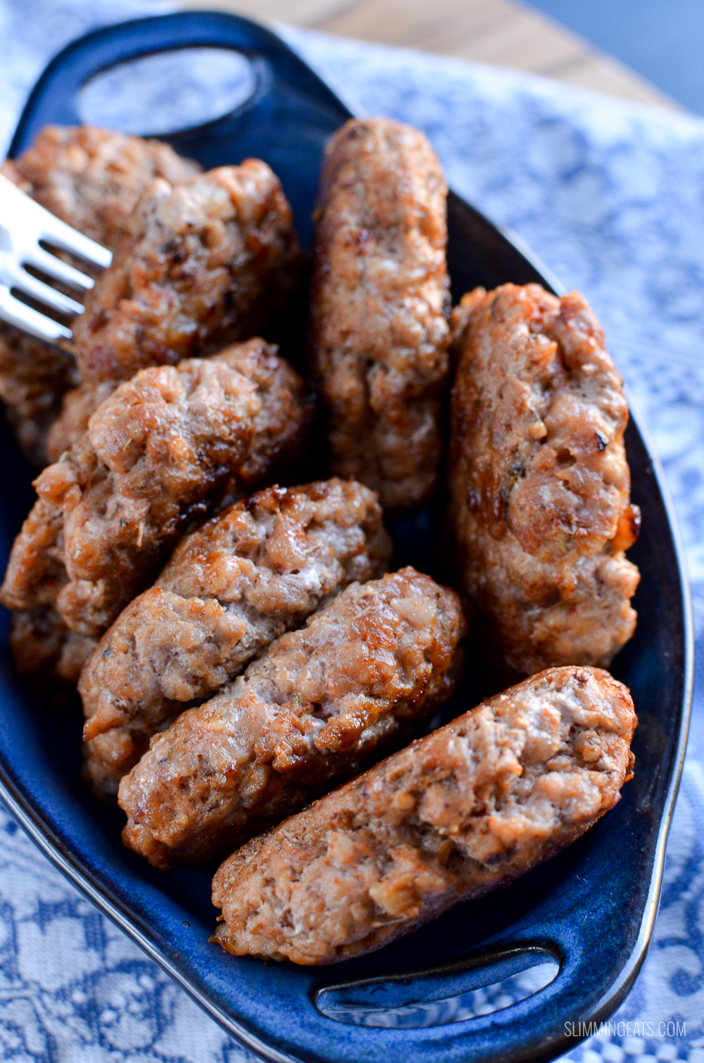 close up of pork sausage breakfast patties in a blue serving dish