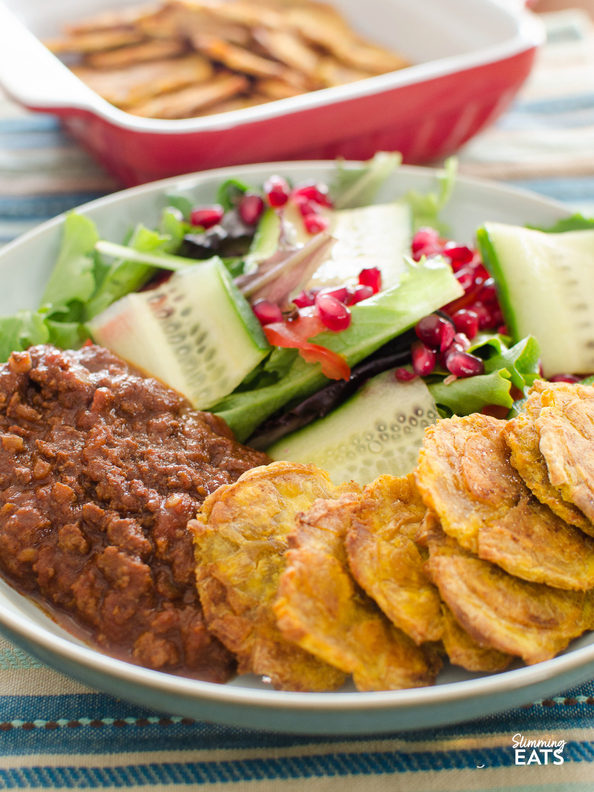 Baked Tostones in a bowl with salad and chilli