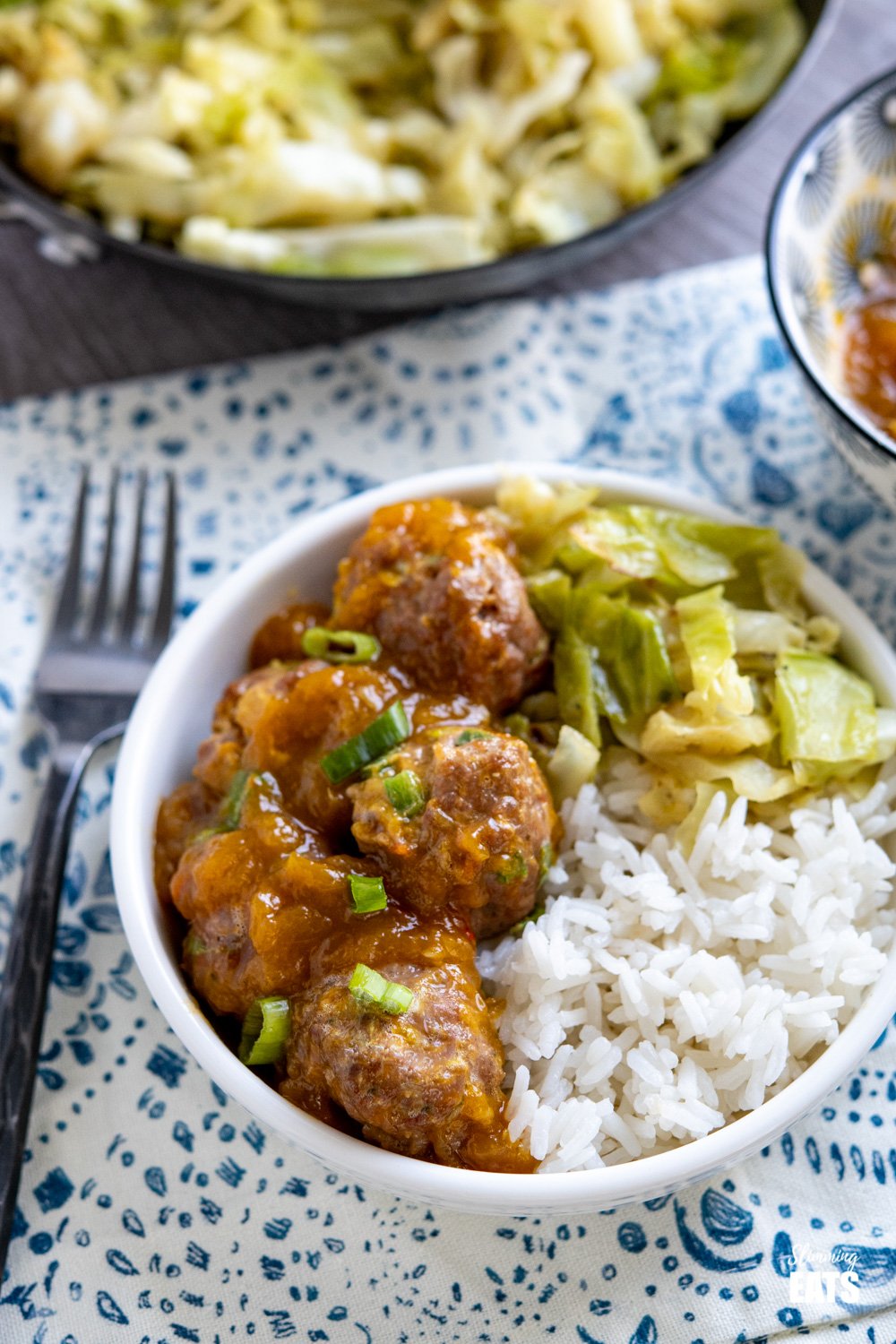 chicken mango meatballs and with spicy mango sauce, rice and cabbage in white bowl