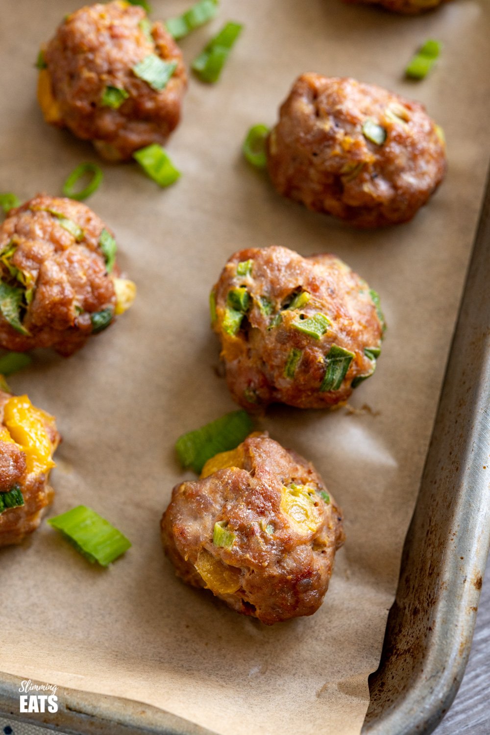 close up of chicken mango meatballs on baking tray