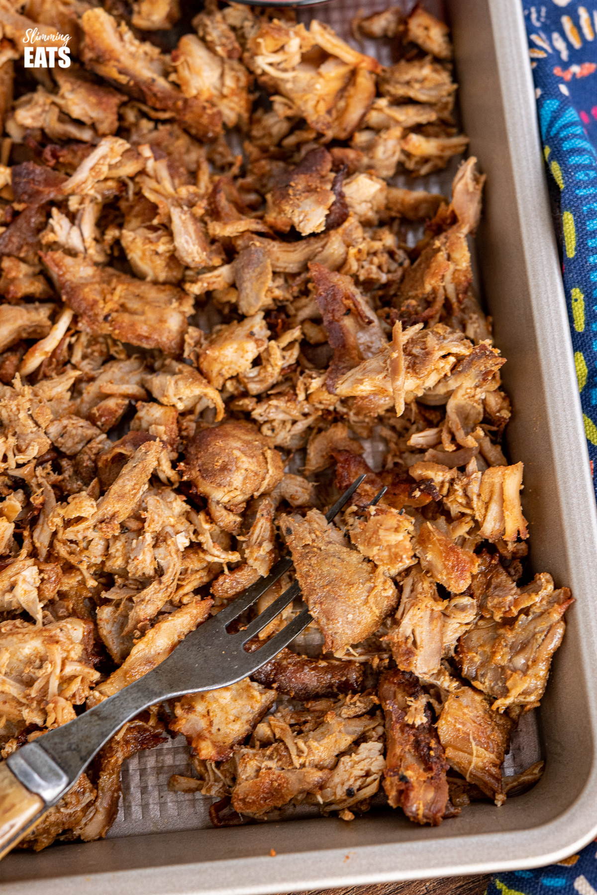 close up of Pulled Pork on baking tray with fork
