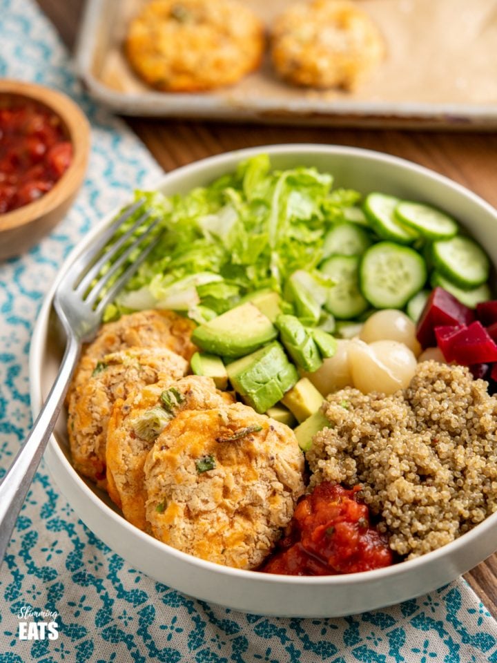 Cheddar Butter Bean Bites in cream bowl with quinoa, cucumber, lettuce, salsa, avocado, beets and picked onions