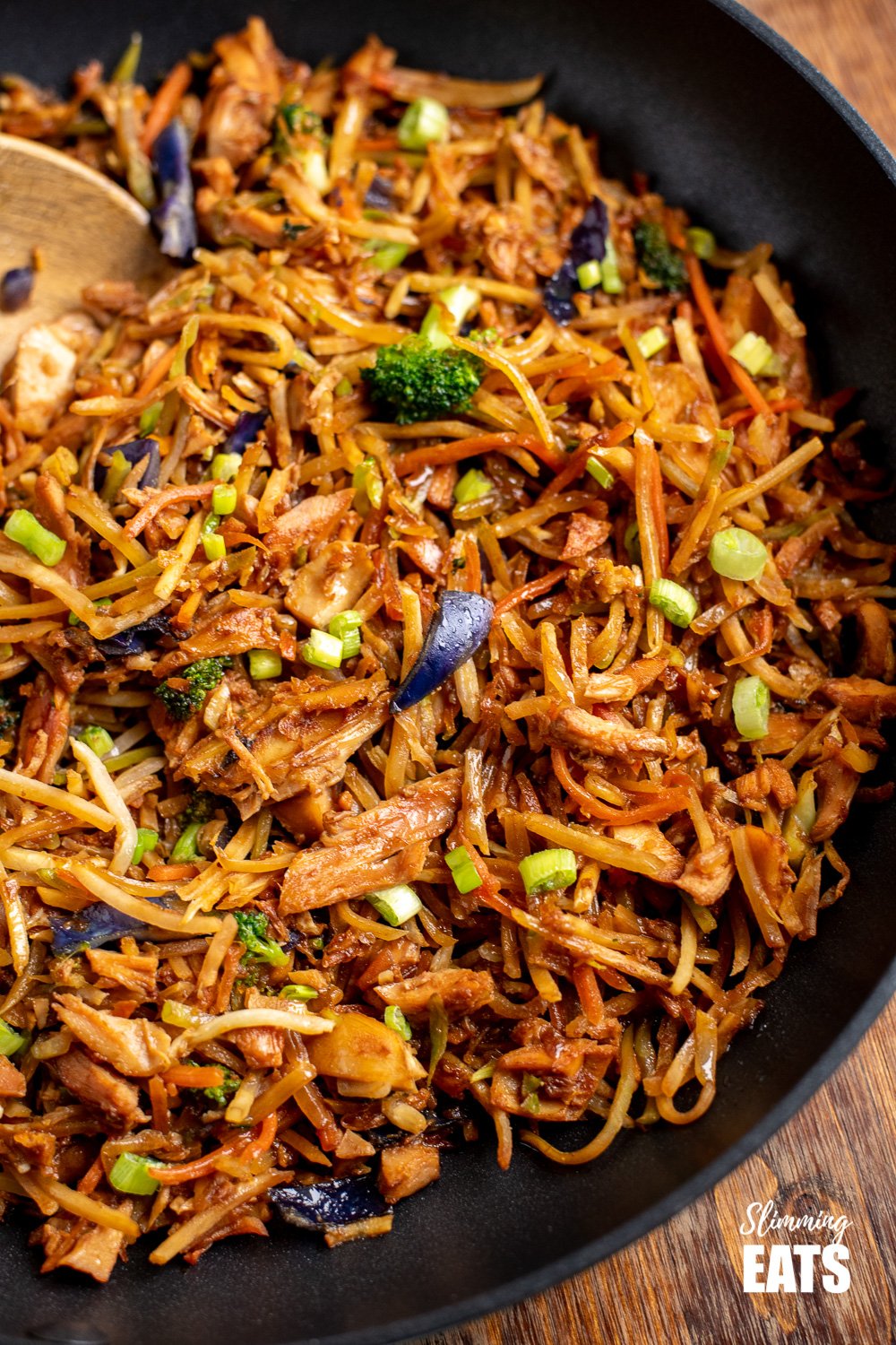 Orange and Ginger Turkey Stir Fry - a simple and flavoursome dish that is perfect for the whole family and ready in minutes. Gluten free, dairy free, Slimming and Weight Watchers friendly close up of orange and ginger turkey stir fry in black frying pan