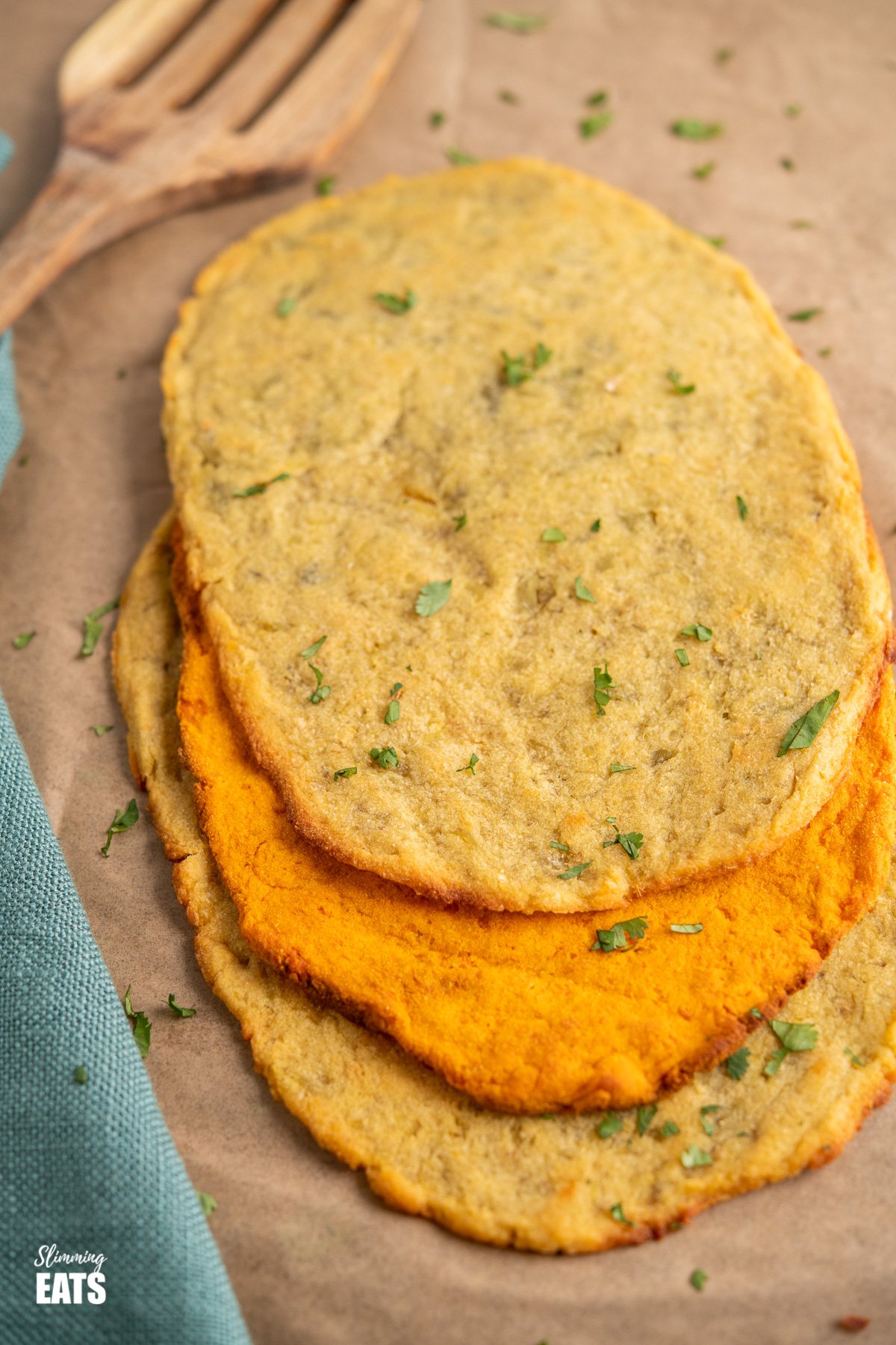 sweet potato flatbread on parchment paper with wooden spatula