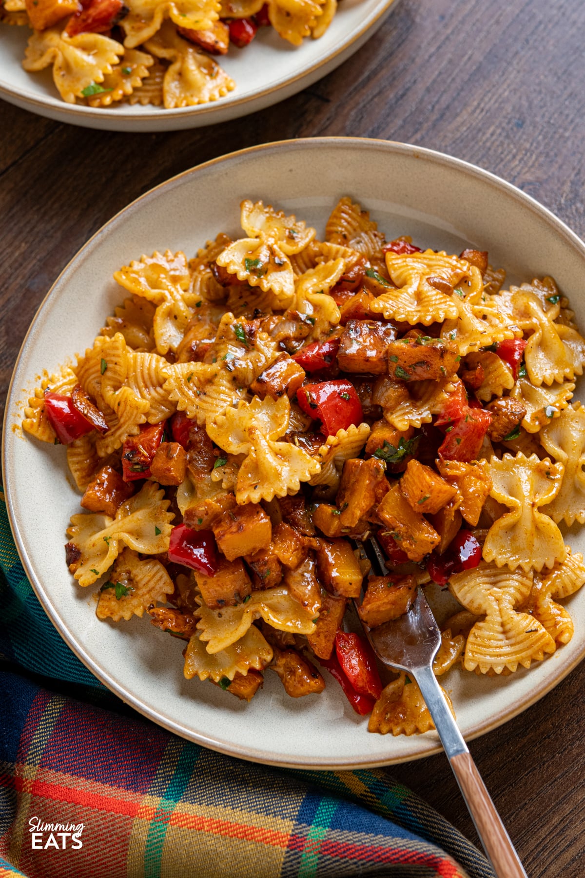 Roasted Butternut Squash and Red Pepper Pasta with Gruyere on white plates with beige rim