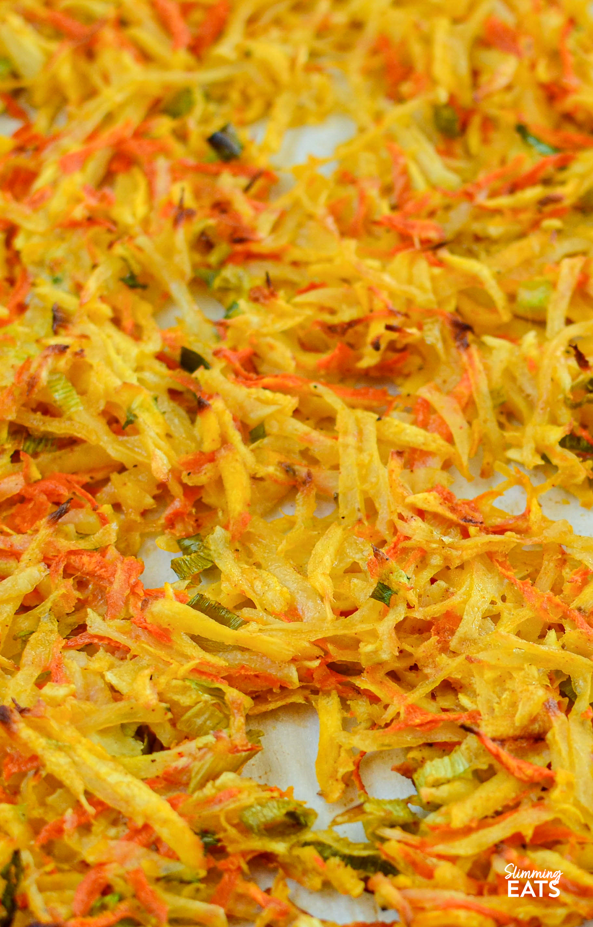 carrot, parsnip and potato hash on a parchment lined tray