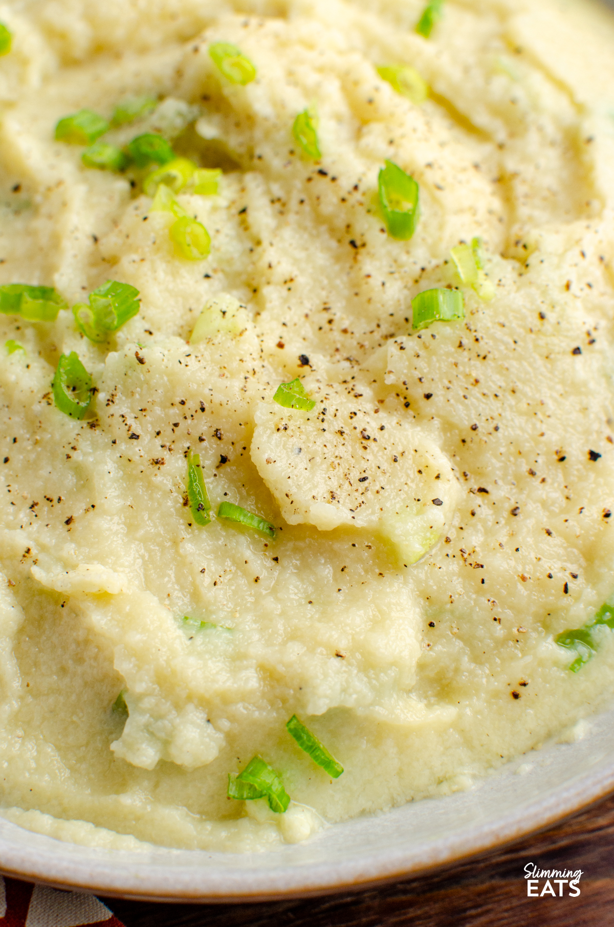 close up of Sour Cream and Spring Onion Cauliflower Mash in a bowl