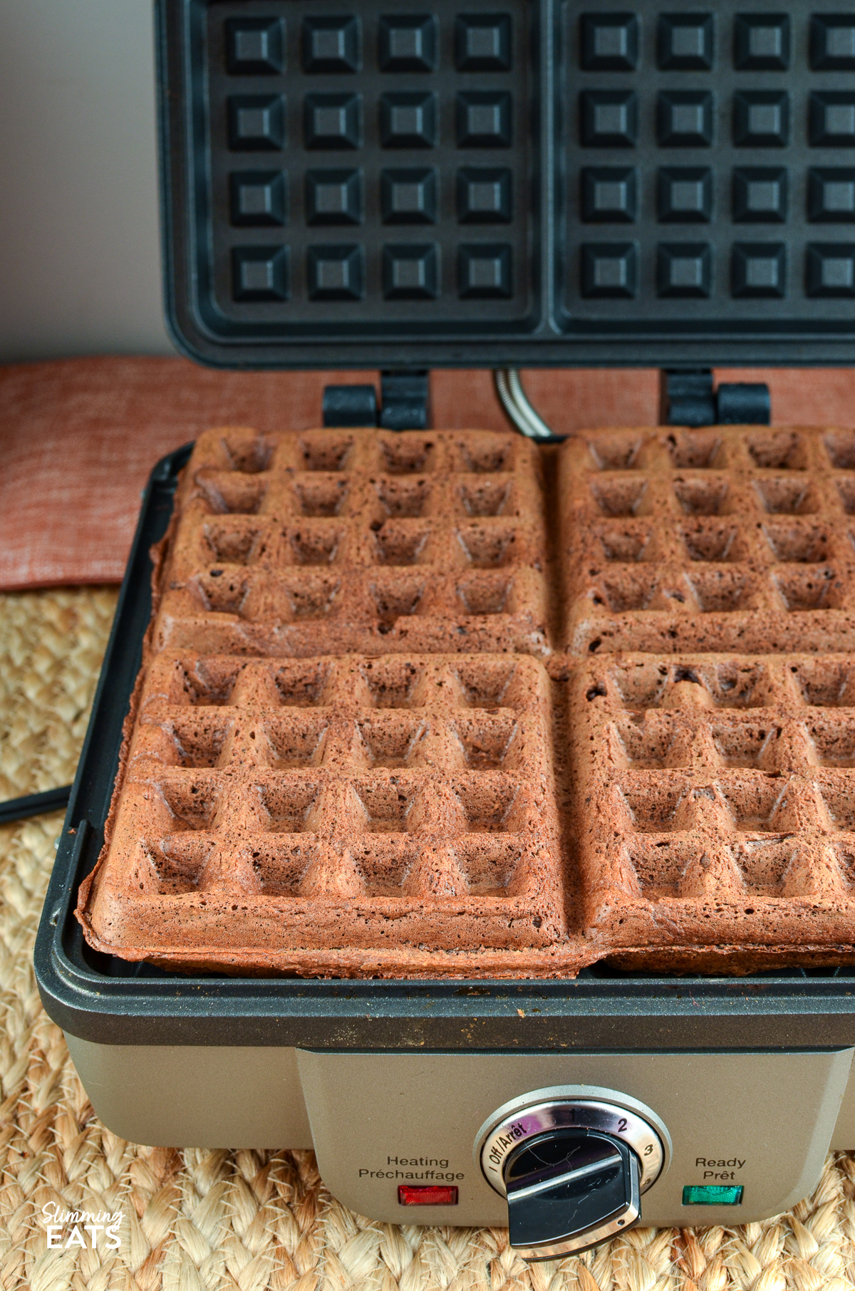 Four square oat chocolate banana waffles freshly cooked and ready to be served.