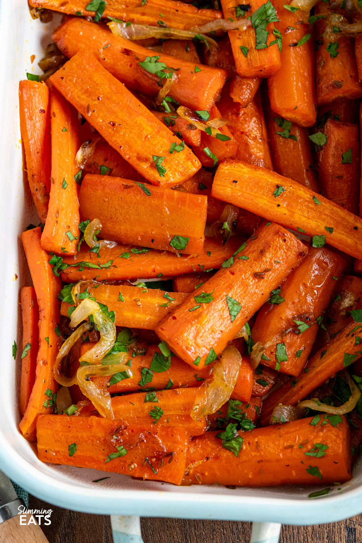 maple glazed carrots in a white and pale blue baking tin