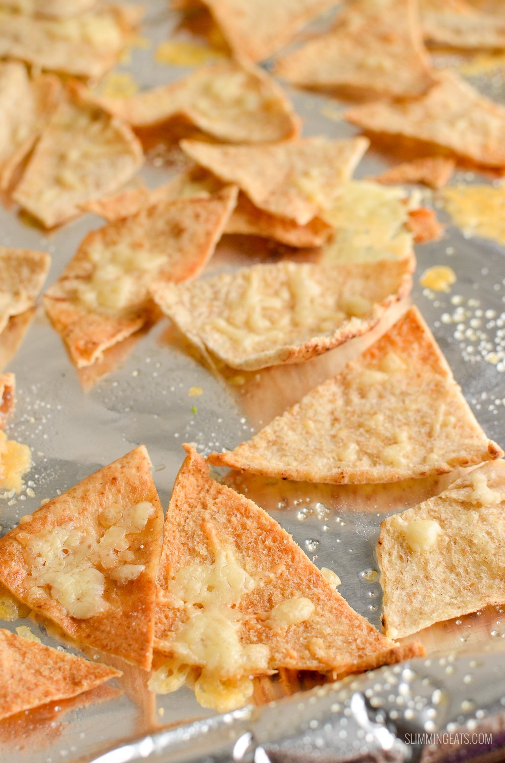 close up of cheddar pita chips on a baking tray