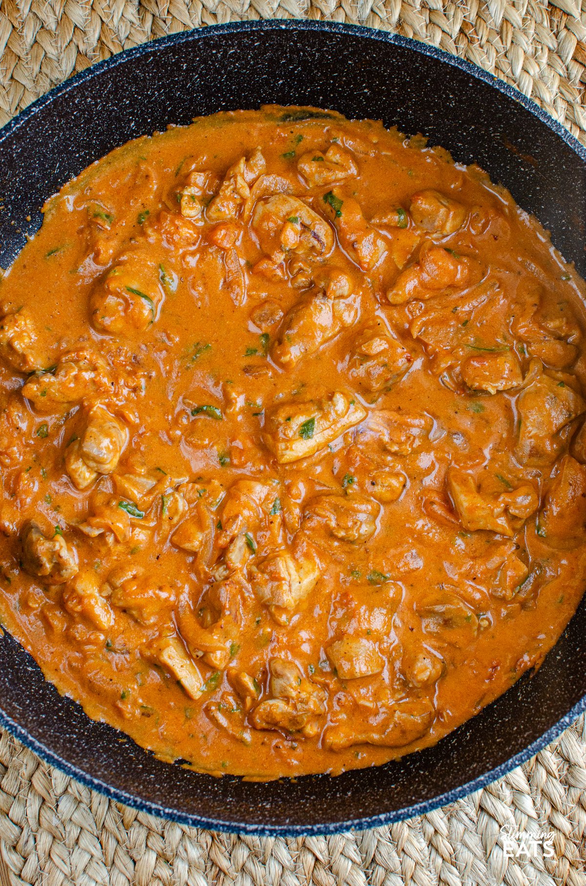 Creamy chicken and tomatoes in a non stick frying pan 