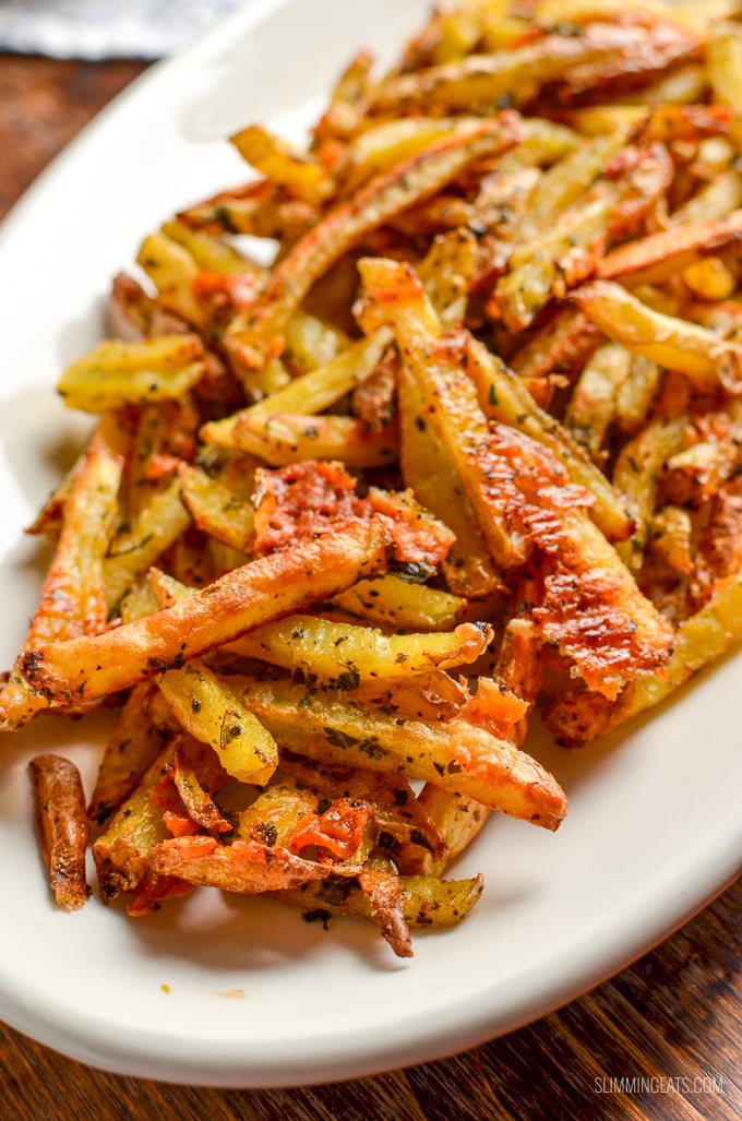 close up of garlic parmesan fries on white plate