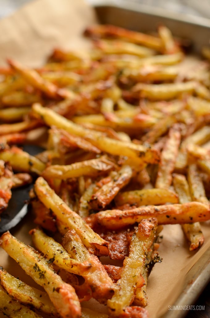 cheesy garlic parmesan fries on tray lined with parchment