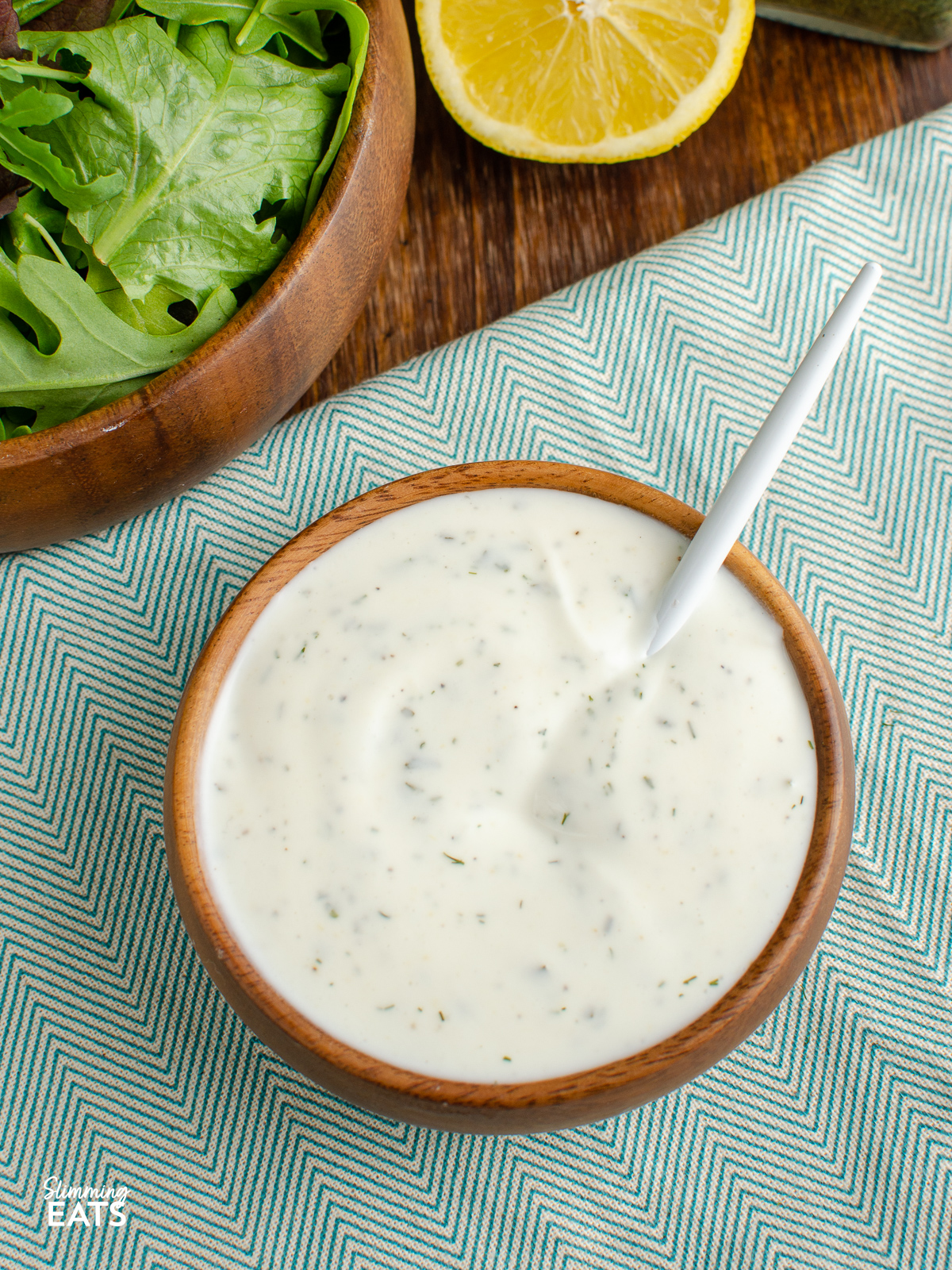 Homemade Light Ranch Yoghurt Dressing in a wooden bowl with spoon