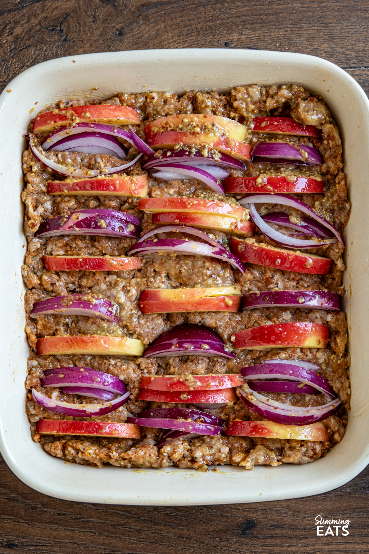 apple and red onion pork apple squares all ready in oven dish to be baked