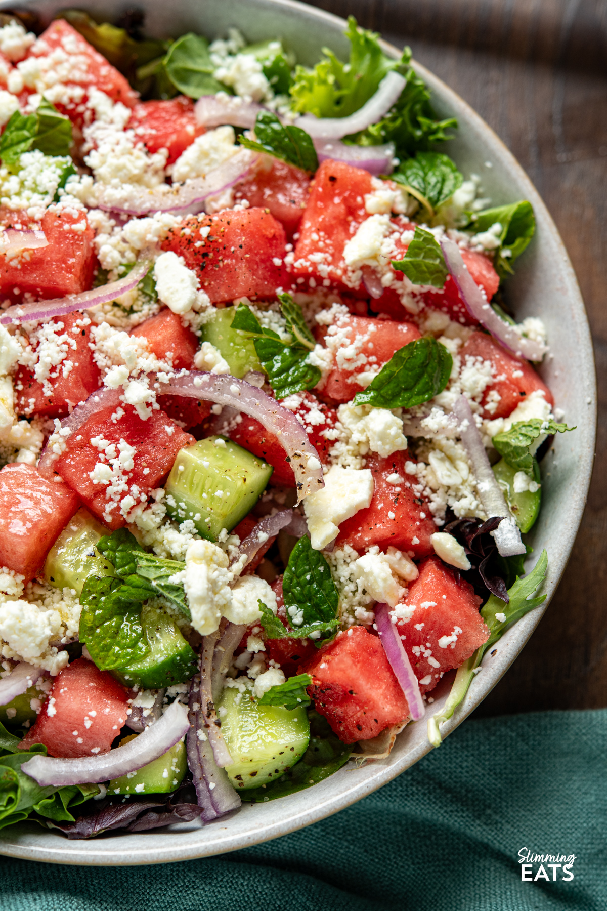 Watermelon feta salad is the perfect fresh and vibrant side for warm days, with juicy watermelon, crisp cucumber, salty feta and a light dressing bringing it all together beautifully. close up of Watermelon and Feta Salad