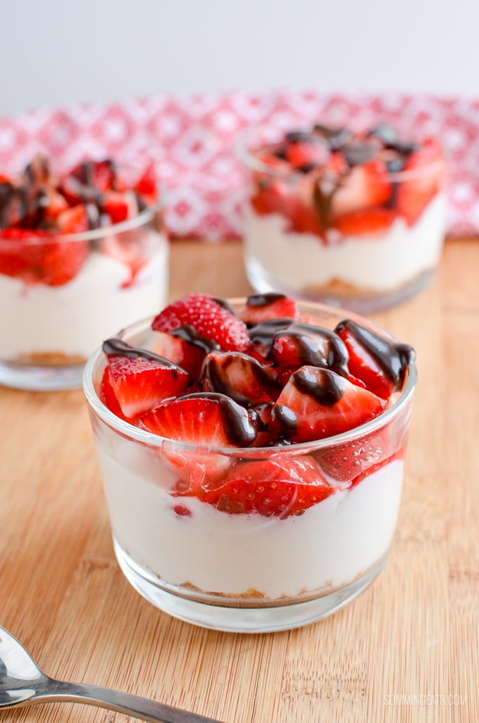 Strawberry Topped Greek Yoghurt Style Cheesecakes - Enjoy one of these delicious Strawberry Cheesecakes that are super quick to make and a delicious treat. Slimming Eats and Weight Watchers friendly strawberry Greek yoghurt cheesecake in glass dish