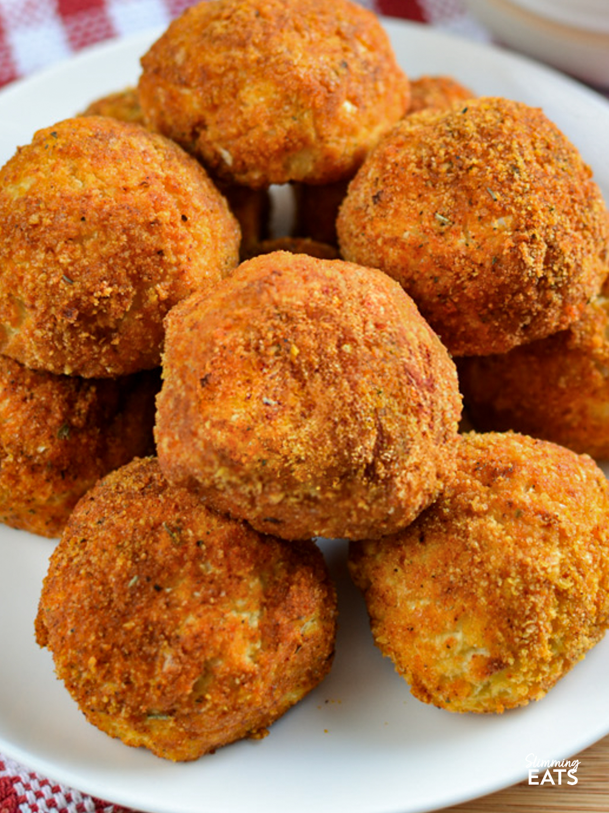 close up of cheddar stuffed cauliflower bites on a white plate
