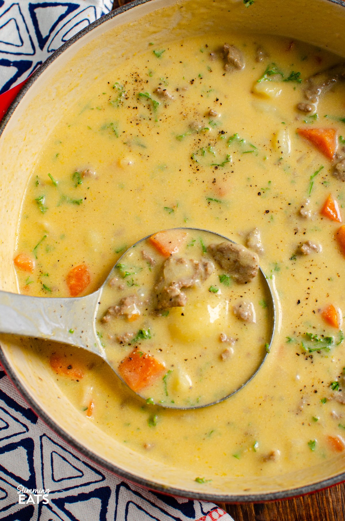 cheeseburger soup in cerise cast iron pot with ladle