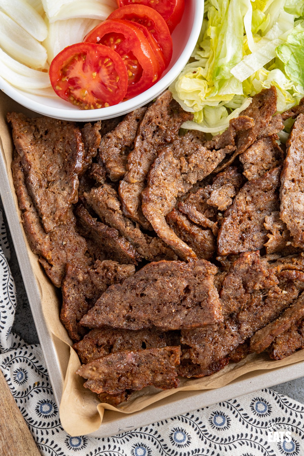 Homemade Doner Kebab Fakeaway Recipe - a delicious homemade version of a popular fakeaway dish, complete with garlic and chilli sauce. It's delish!! #slimmingeats #weightwatchers close up of doner kebab meat on baking tray