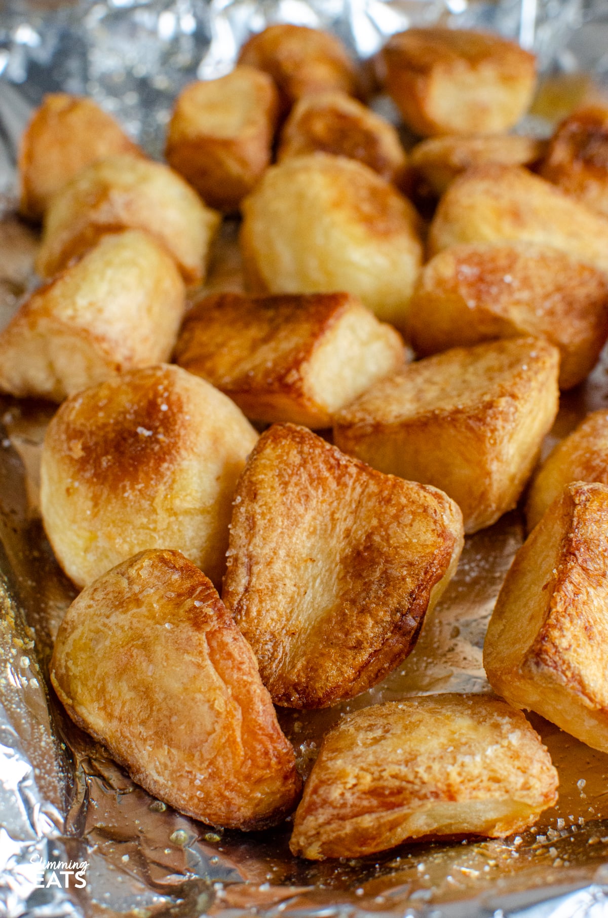 cooked roast potatoes on foil lined baking tray