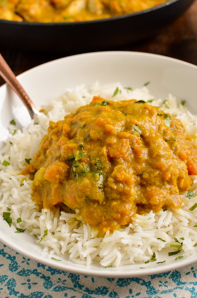 close up of spoon in a bowl of Coconut Chicken and Sweet Potato Curry with rice