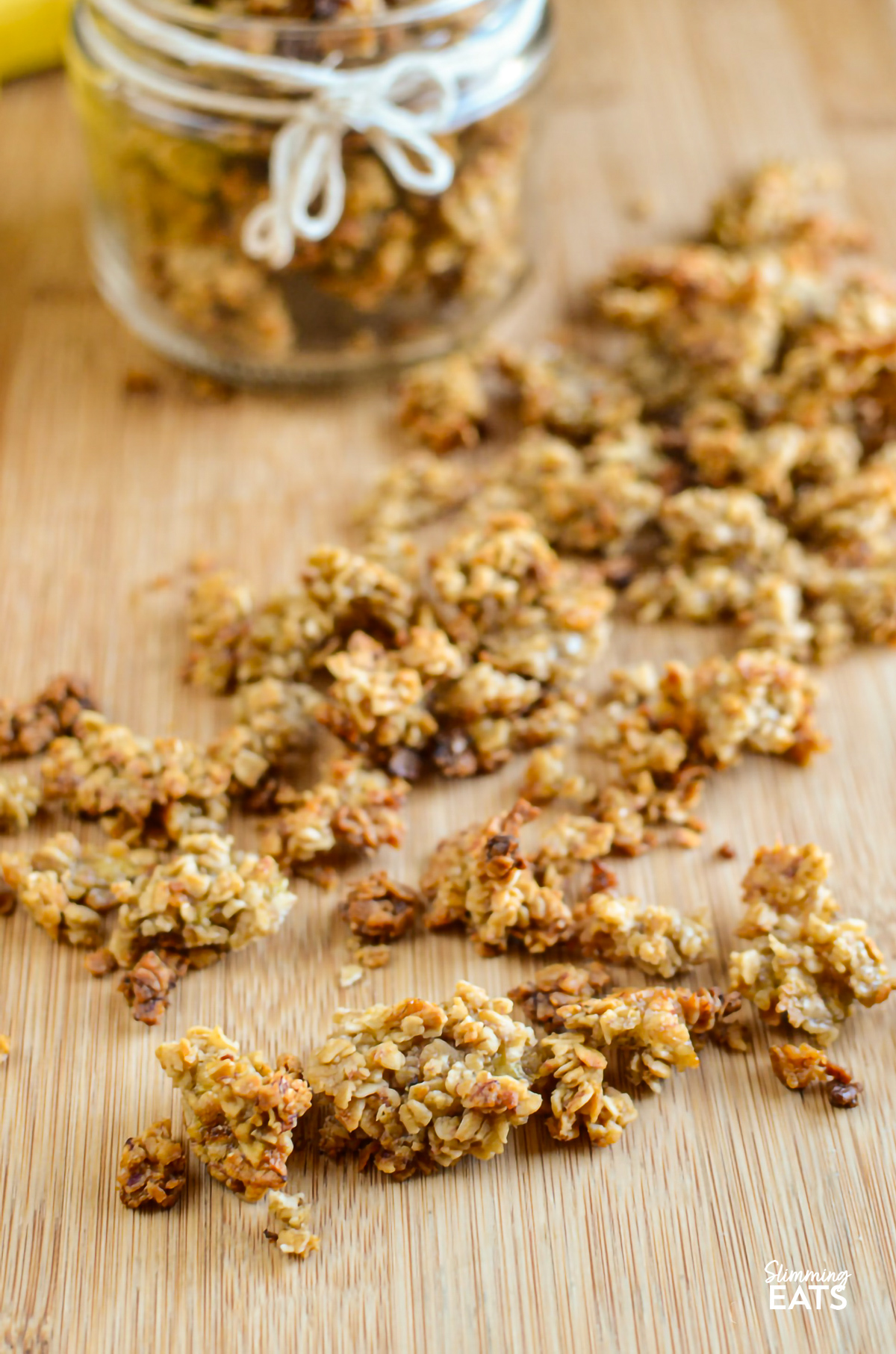 Banana granola scattered on a wooden board