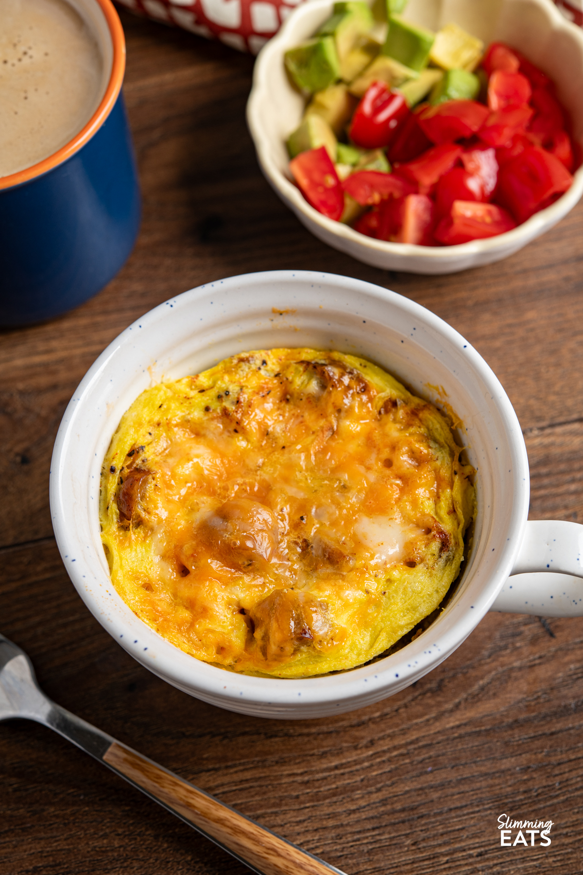 Need a quick breakfast that still feels filling? This Breakfast in a Mug is perfect for those mornings when you want something warm and satisfying, without spending ages in the kitchen. Breakfast in a Mug with bowl with tomatoes and avocado and blue mug of coffee