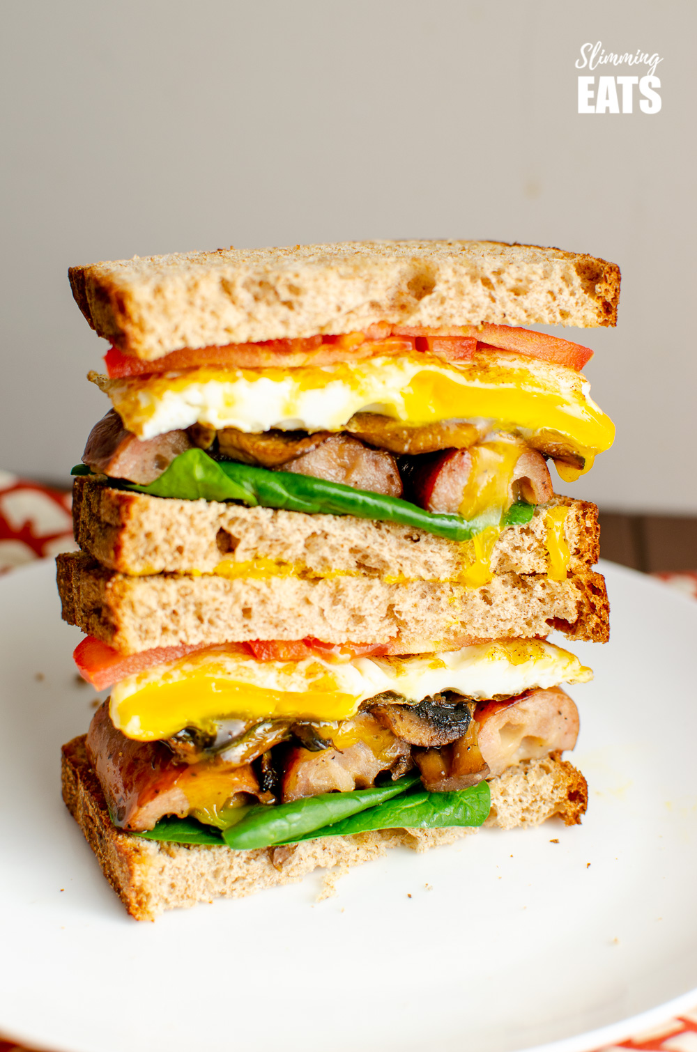 stacked Ultimate Breakfast Sandwich on white plate