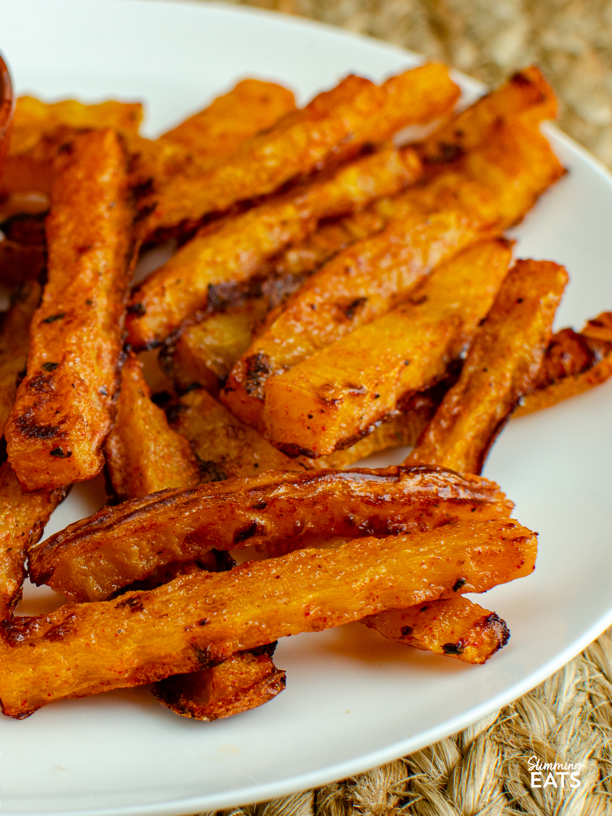 cooked butternut squash fries on a white plate