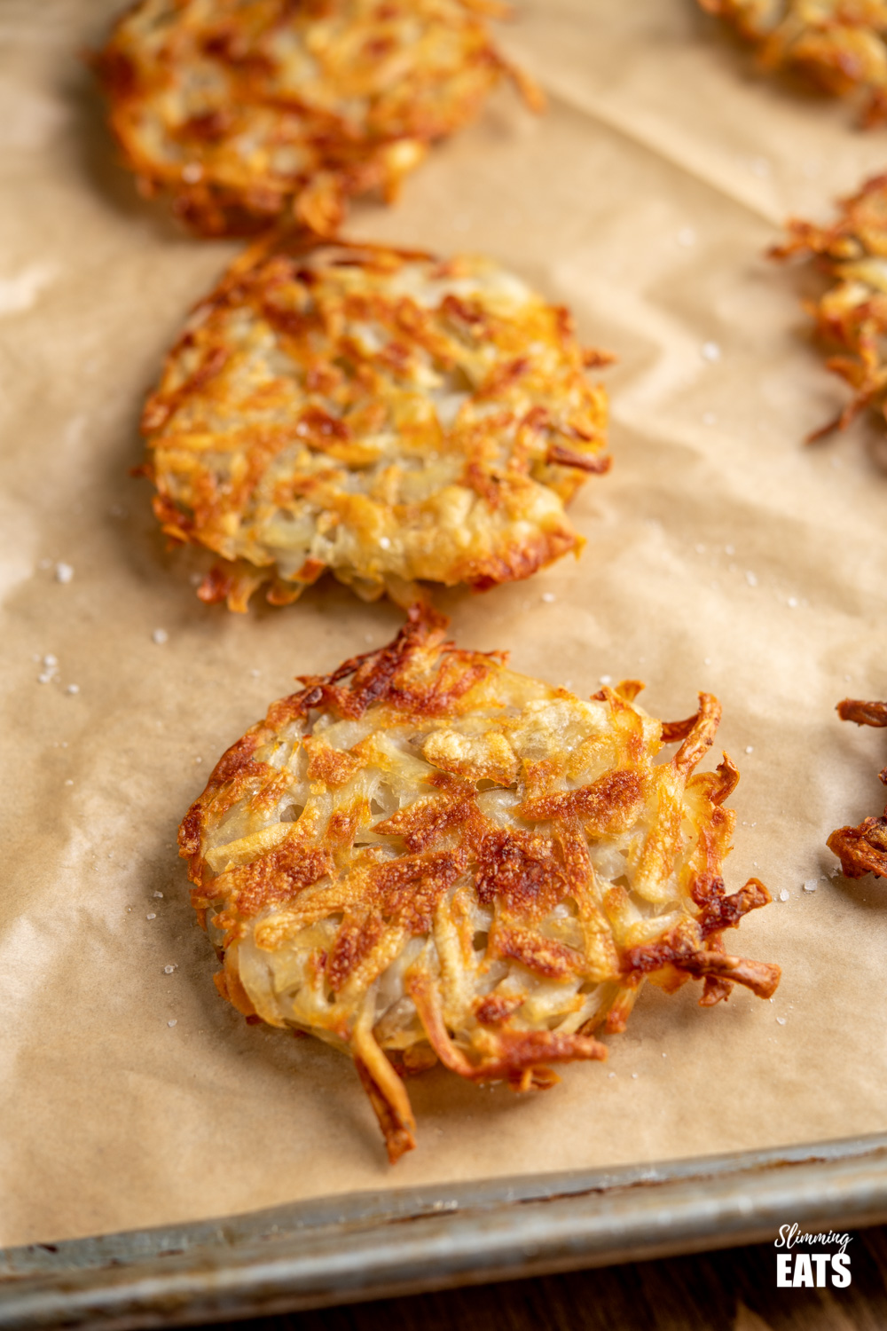 close up of hash brown on a parchment lined baking tray