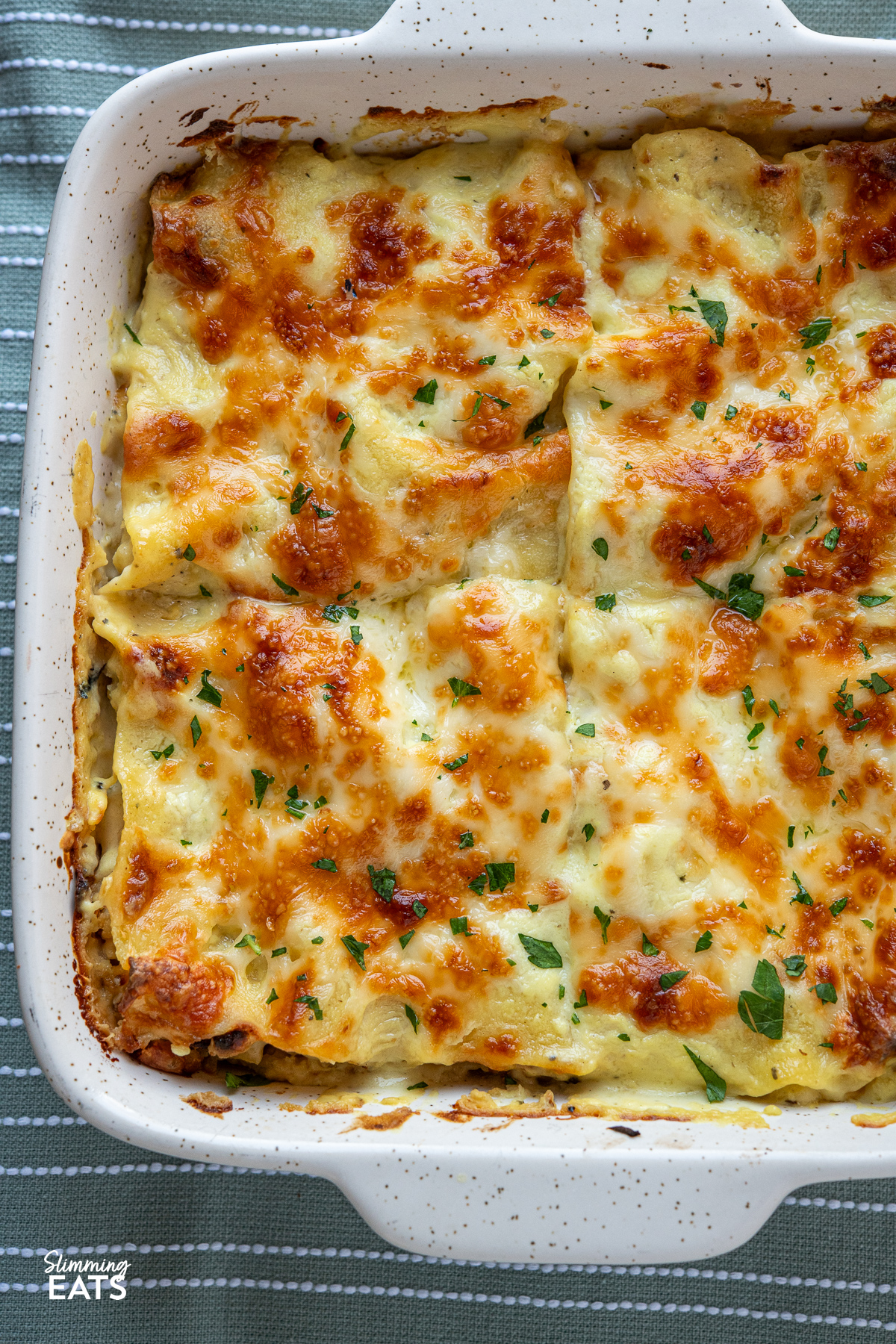 close up of Roasted cauliflower lasagne in a white baking dish