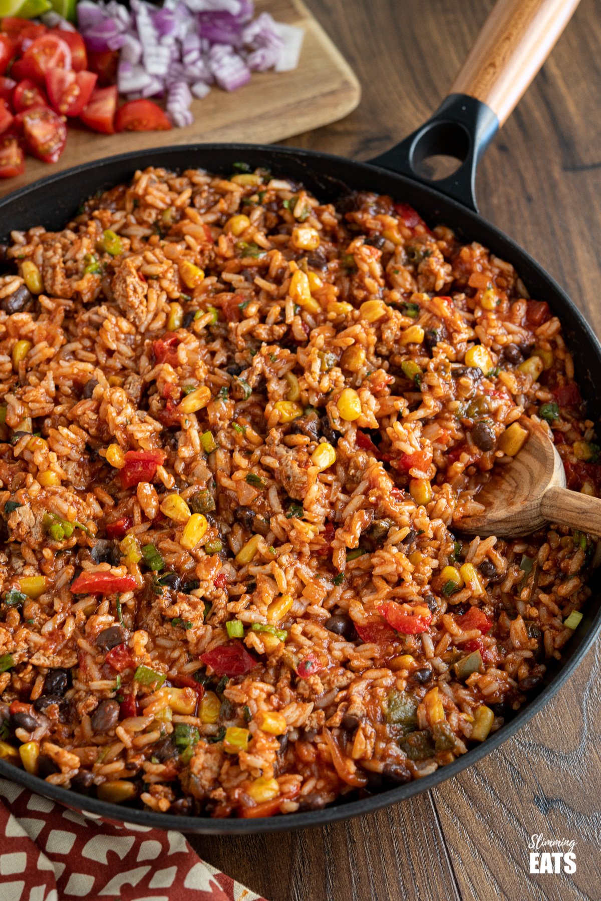 These Turkey Rice Burrito Bowls make a great family meal - sit down and grab a bowl with your favourite toppings. Gluten free, dairy free, Slimming Eats and Weight Watchers friendly turkey burrito rice in black frying pan with olive wood spoon