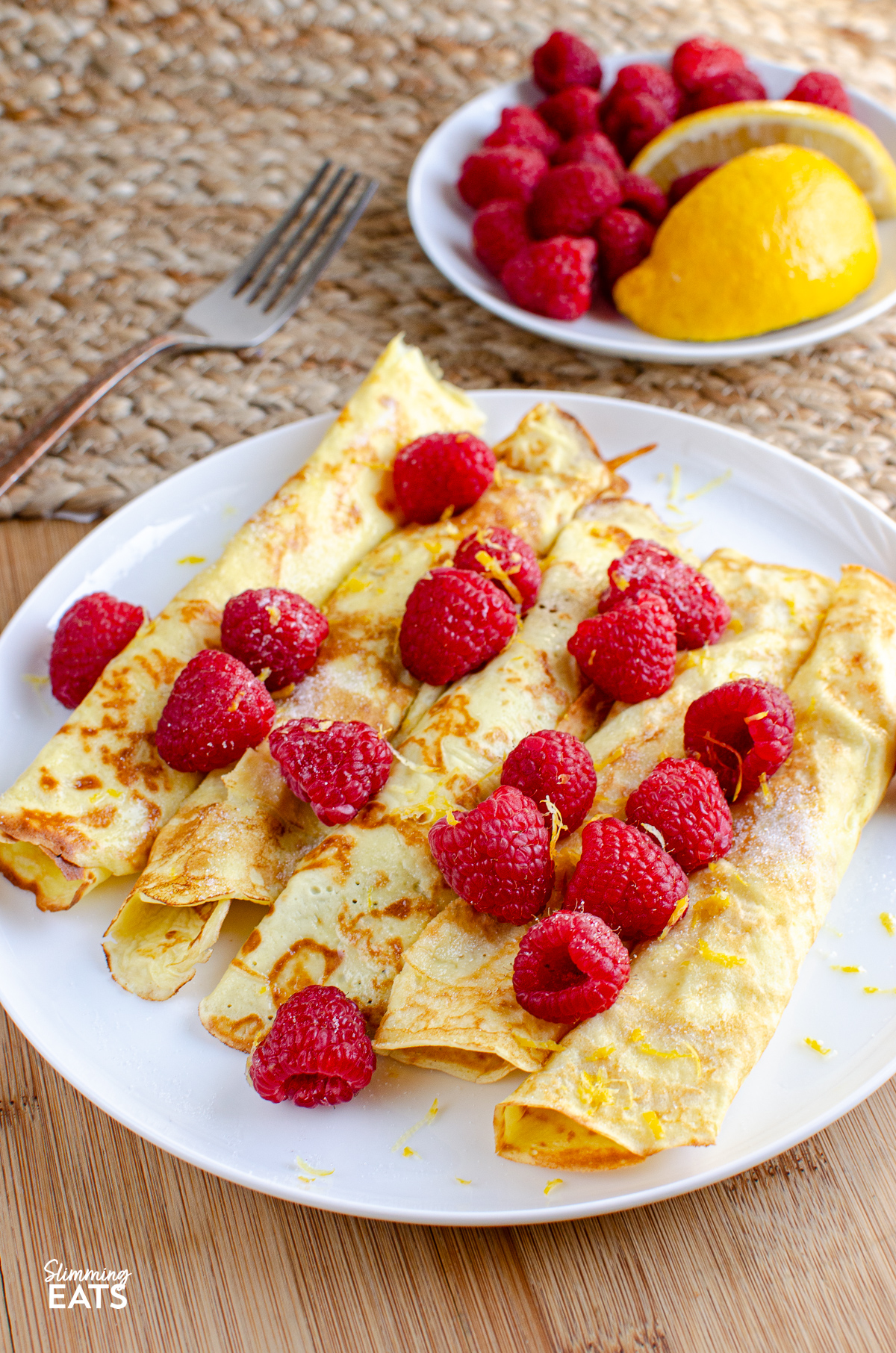 Delicious Low Calorie Crepe Style Pancakes -  with fresh raspberries and a little juice and zest of lemon. 