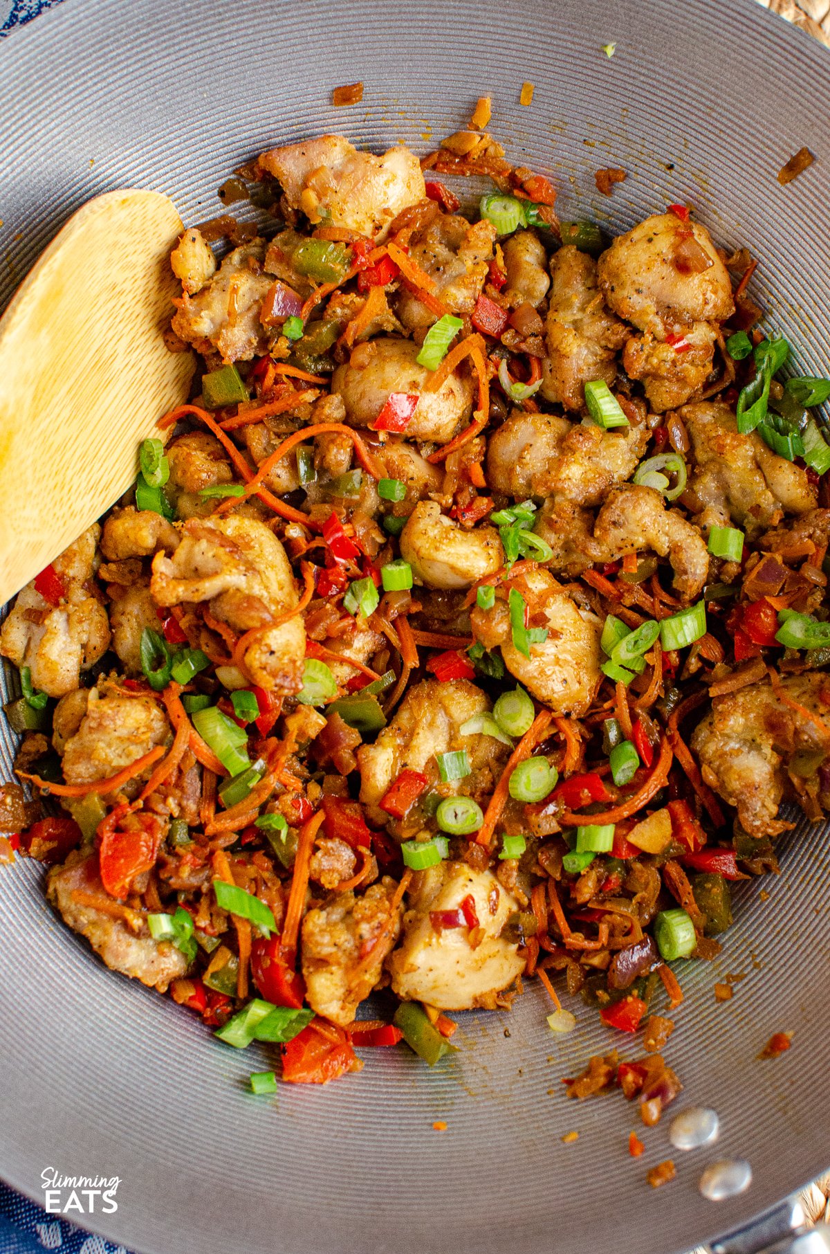 Salt and Pepper Chicken - create this popular Chinese dish in your own home, perfectly SliIf you're a fan of Chinese cuisine but are looking for a healthier alternative to your favorite dishes, look no further than salt and pepper chicken. This classic dish is typically deep-fried and high in calories, but by using an air fryer or oven instead, you can significantly reduce the fat content without sacrificing flavor. salt and pepper chicken in a wok