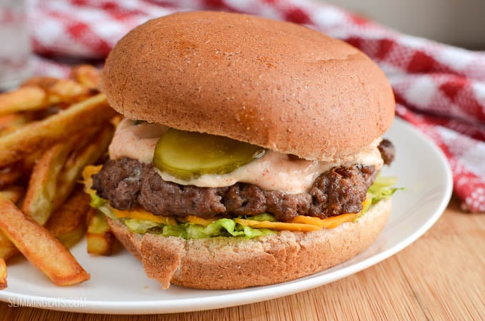 Big Mac and Fries Fakeaway - A healthier take on a everyone's favourite fast food burger meal. That can also be made using healthy extras and a few changes to the sauce. Slimming Eats and Weight Watchers friendly Fakeaway - create you favourite fast food meal with this healthier Slimming Eats and Weight Watchers friendly version close up of lighter version of big mac and fries fakeaway on a white plate with glass of water and red and white napkin
